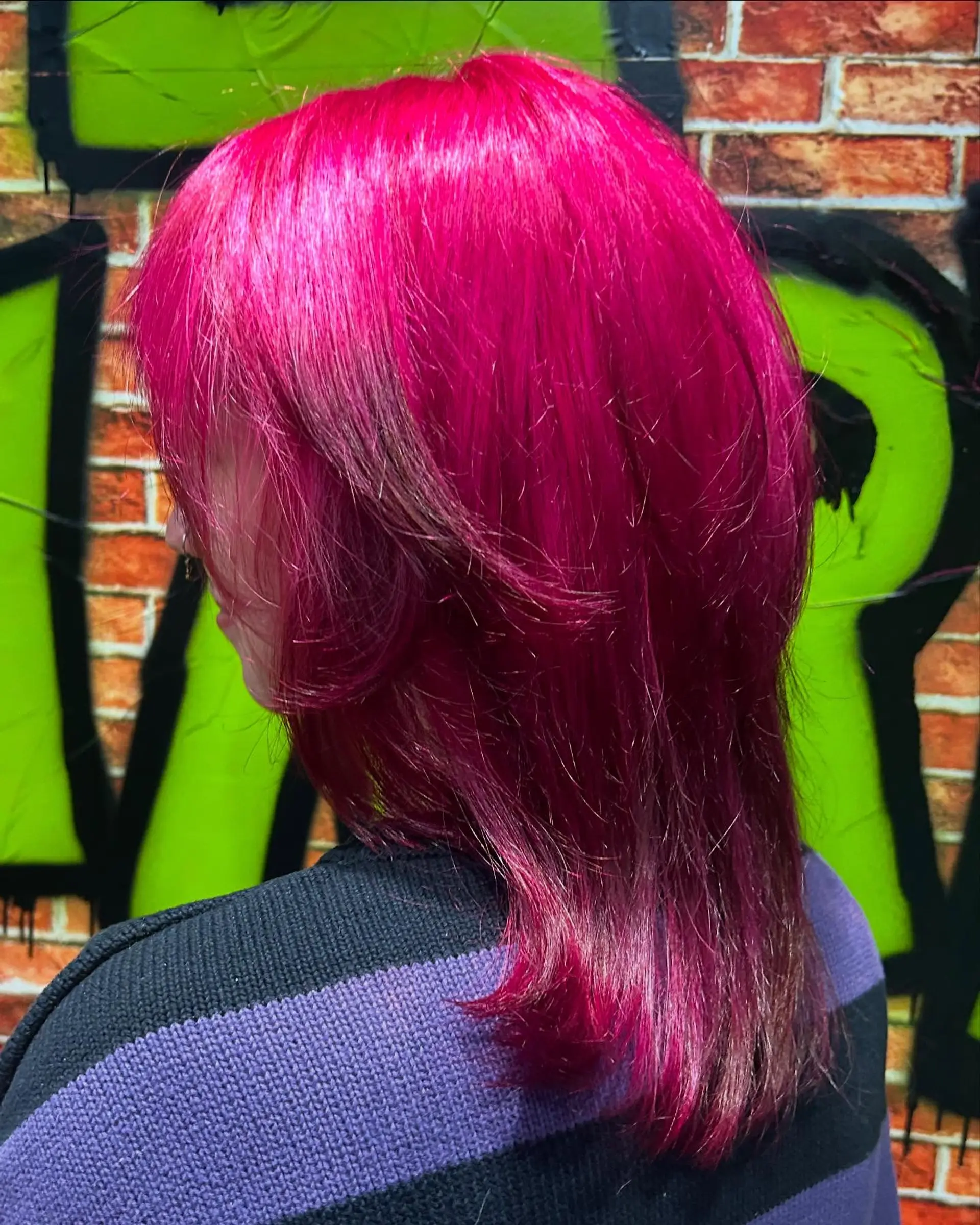 Medium-length layered shag haircut dyed in a vibrant, all-over hot pink vivid tone. 1