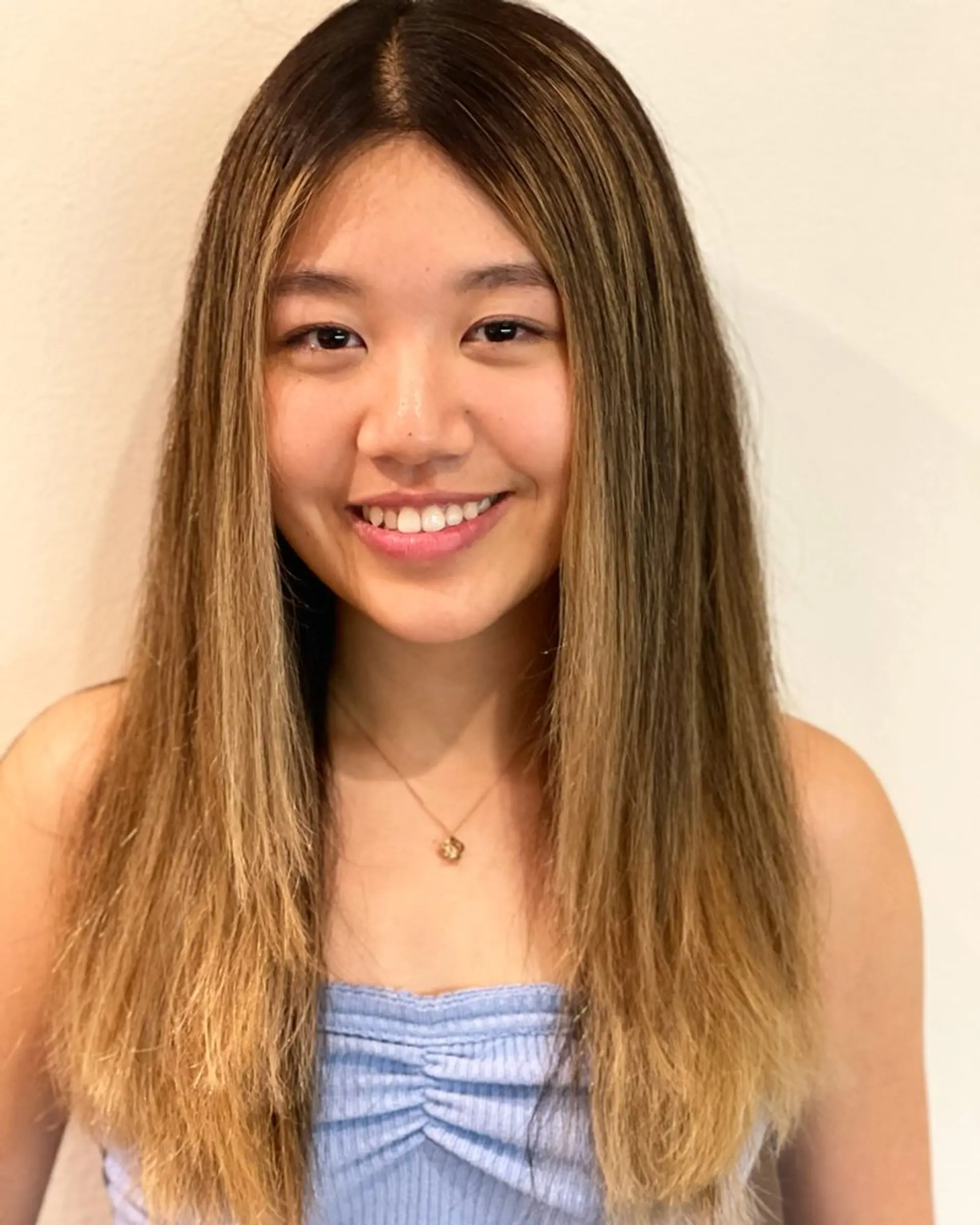 A long, straight hairstyle with a bronde balayage, featuring a blend of brown and blonde tones. 1