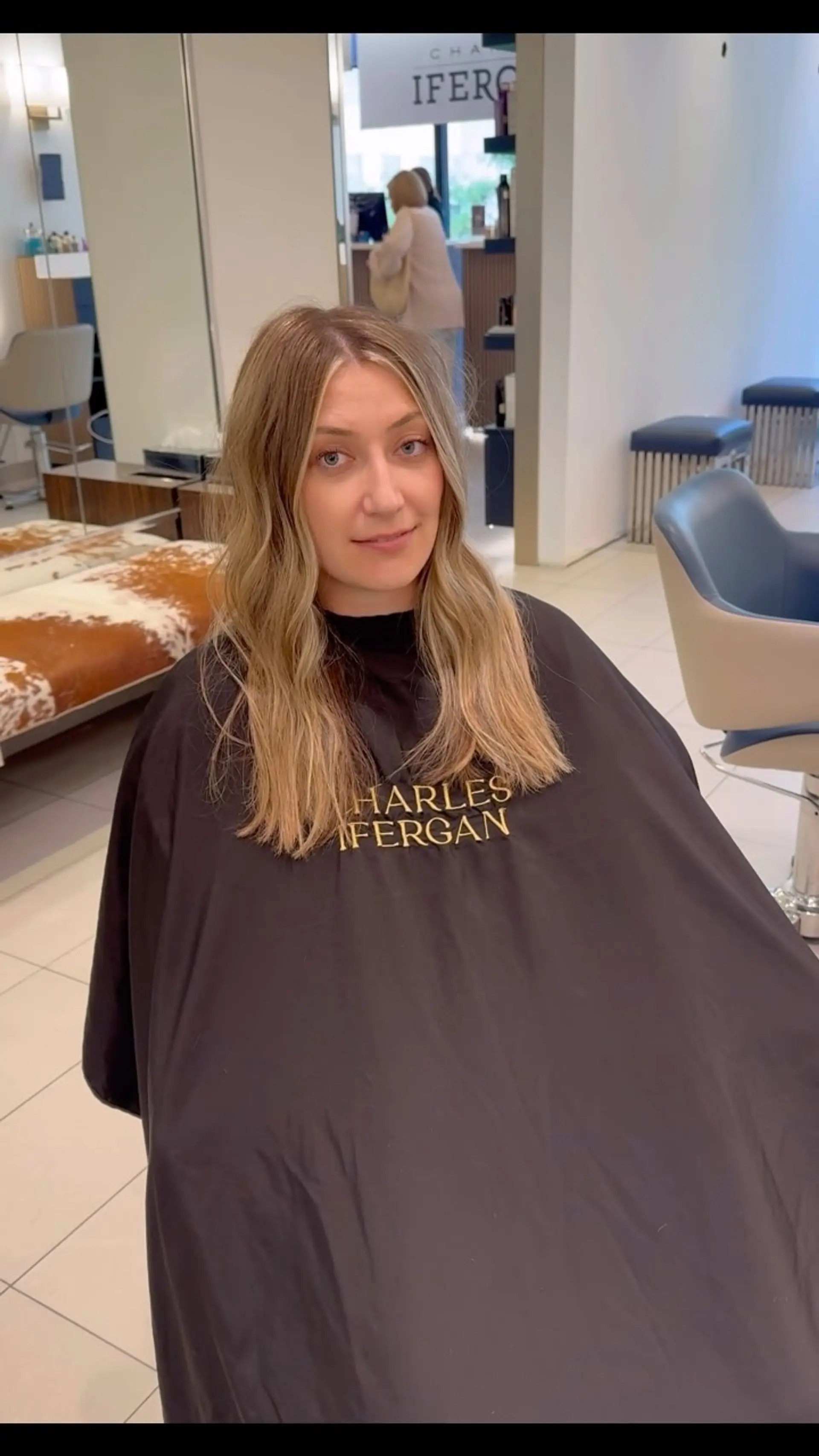 Long hair featuring dimensional blonde balayage highlights styled in soft, relaxed waves with a center part. 1