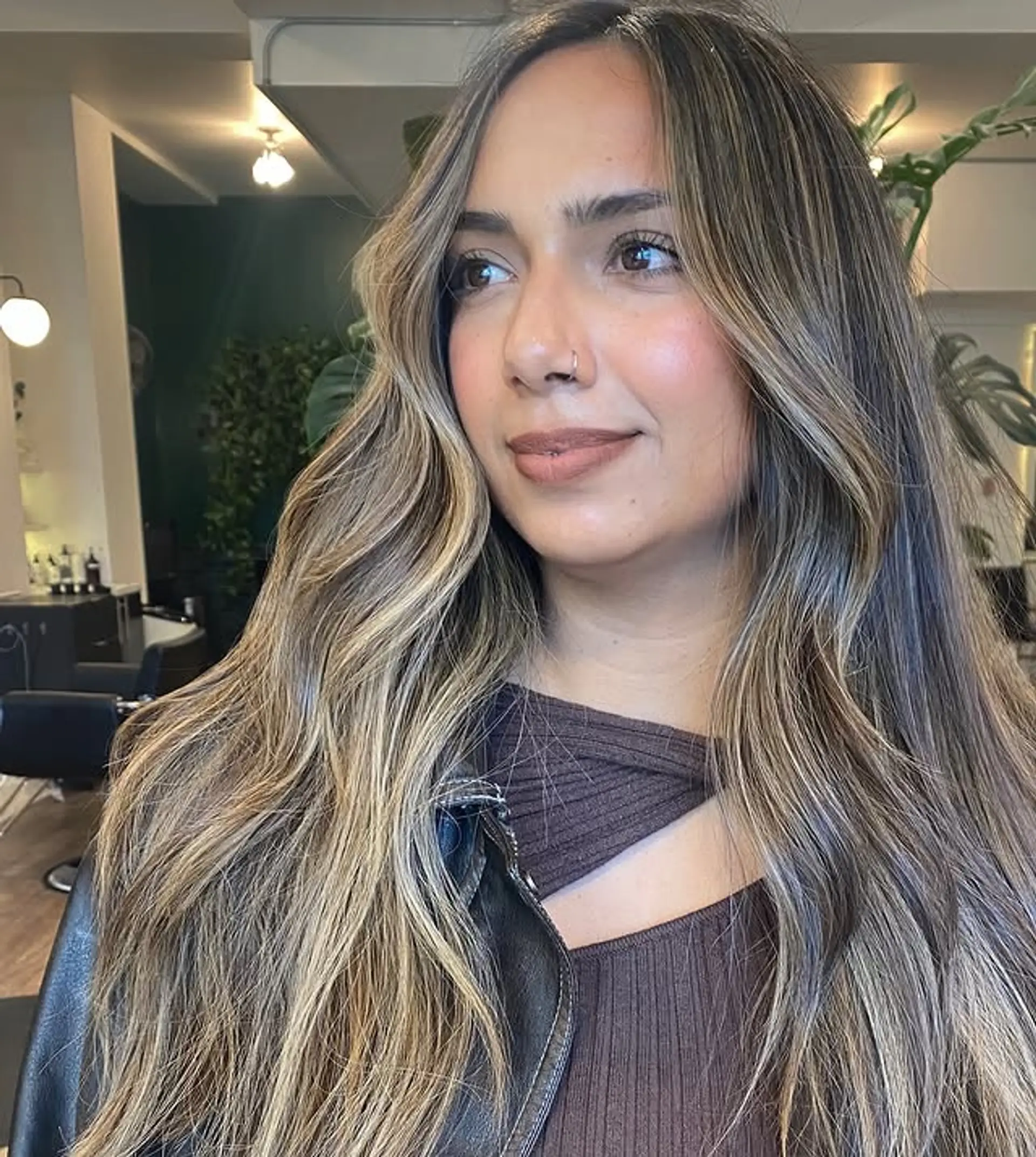 Long, wavy hair with a balayage that blends dark roots into blonde tips. 1