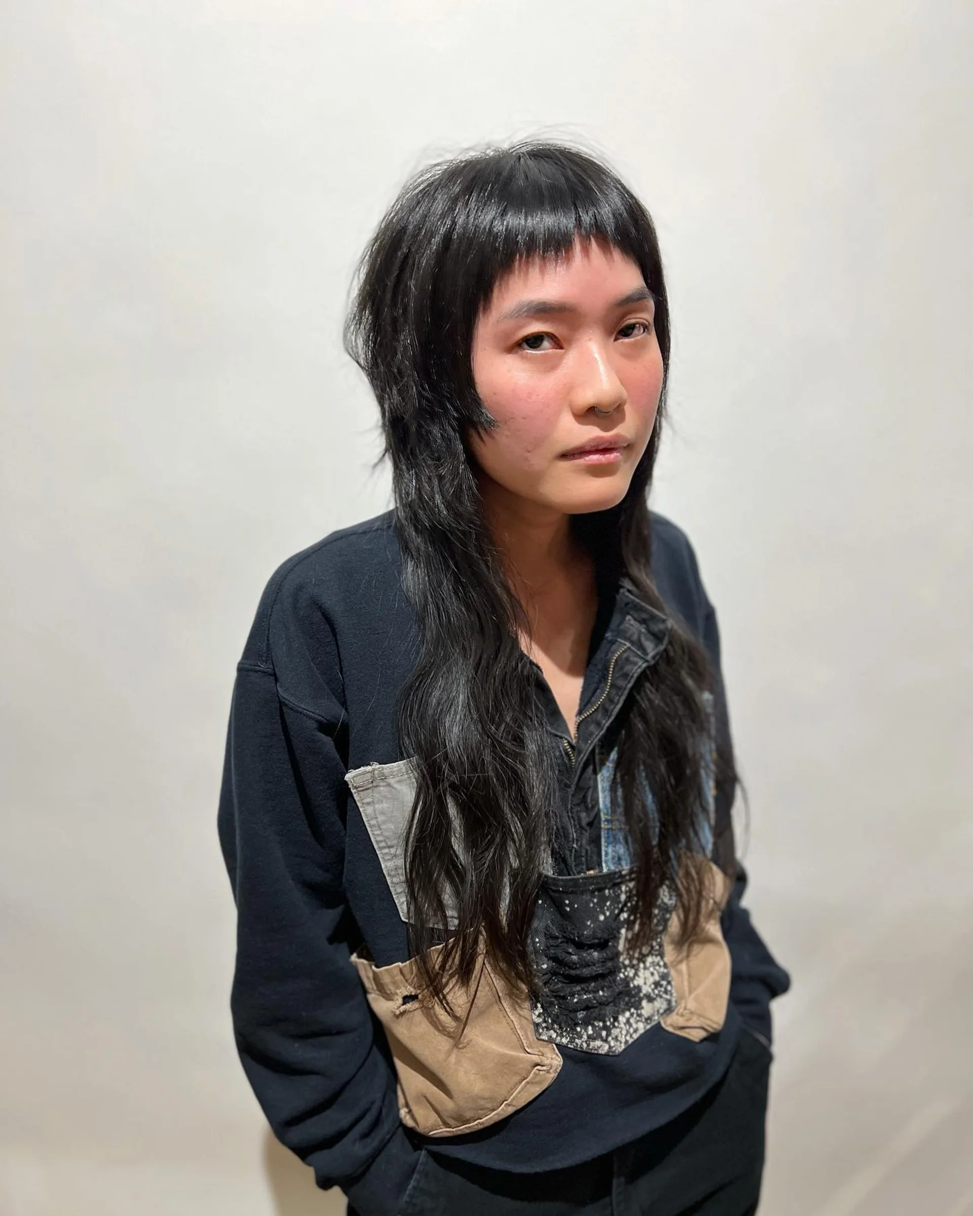 Female model with a modern textured mullet and baby bangs - Preview 3
