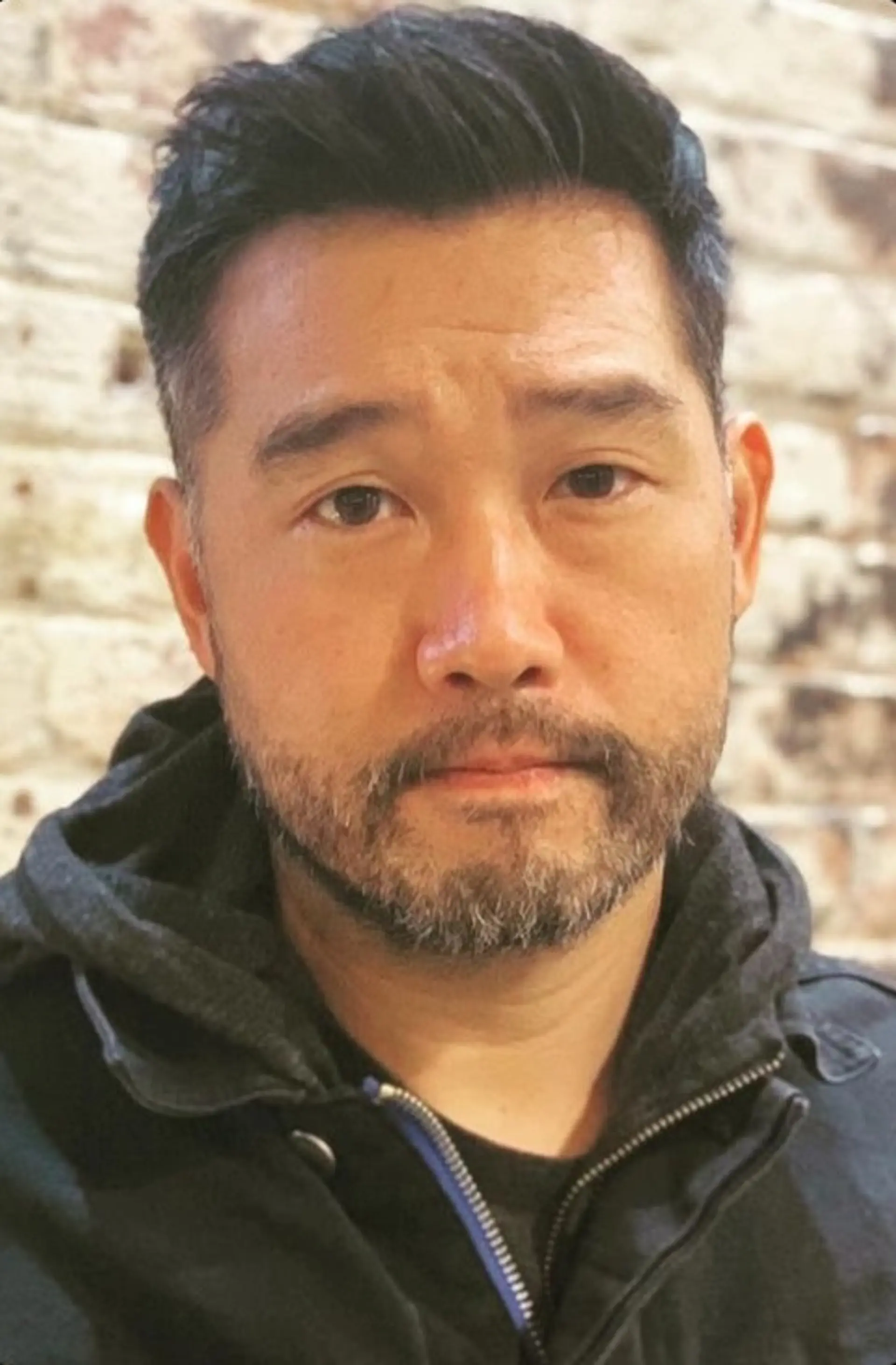 Short, straight hairstyle with a clean fade on the sides and back, textured top, and a subtle side part. Complemented by a well-groomed short beard, perfect for a professional look. 2