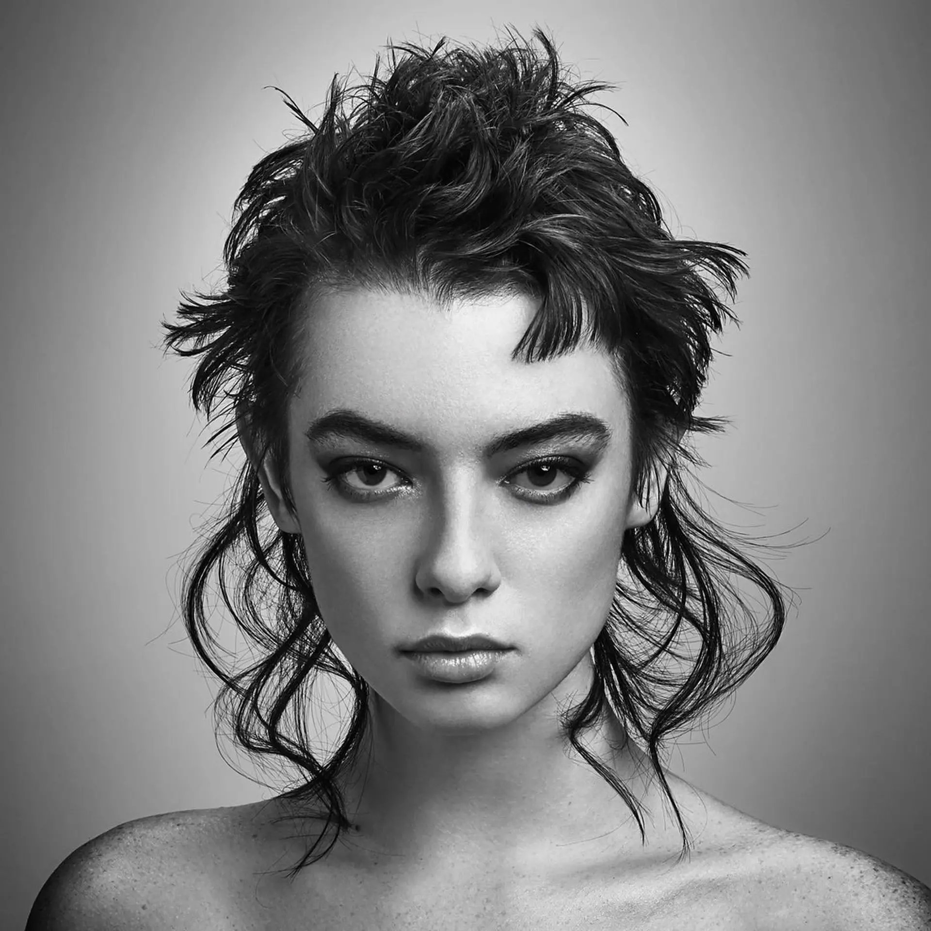 An avant-garde, textured modern mullet featuring spiky crown layers, micro fringe, and wispy, elongated neck tendrils. 1