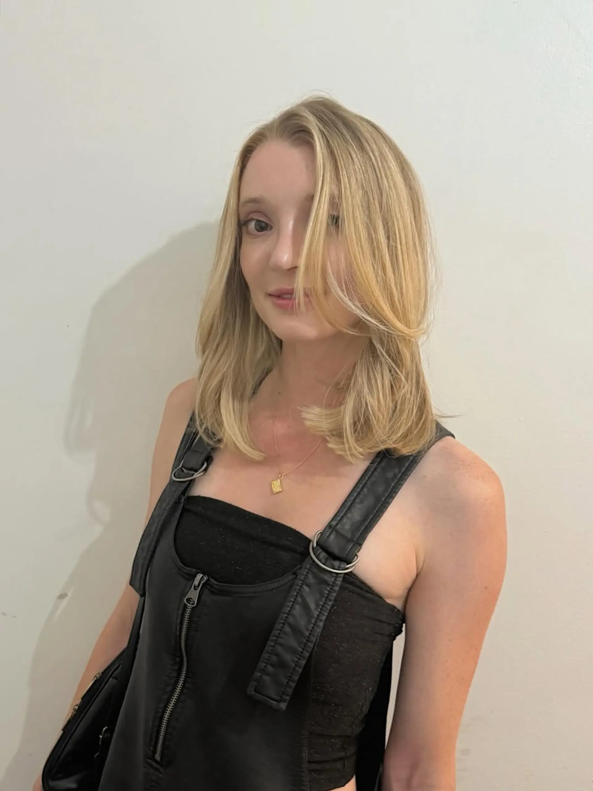A sophisticated medium-length haircut characterized by soft, face-framing layers and a subtle, side-swept fringe, perfect for adding movement and dimension. 1