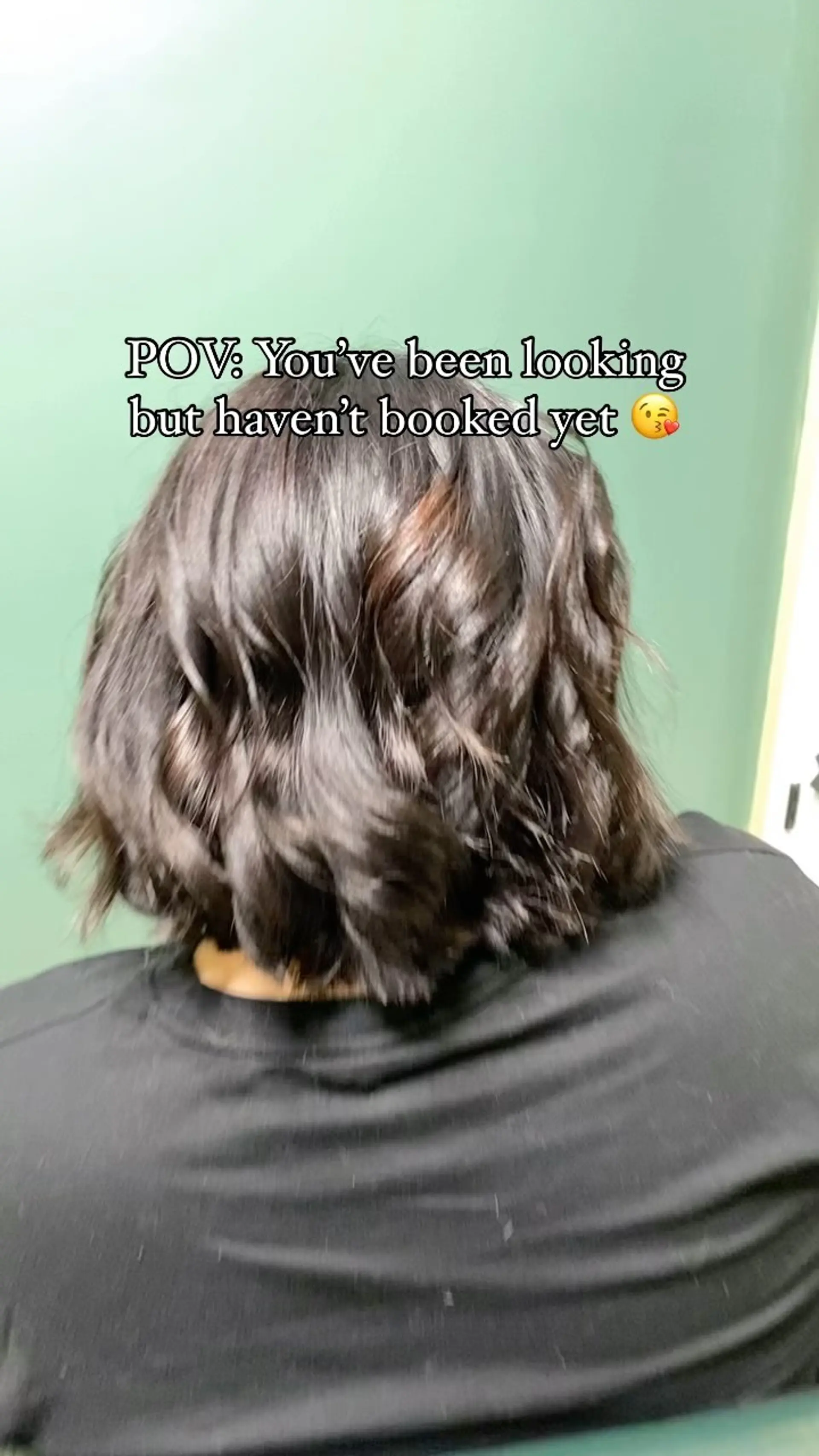 A textured short dark brown bob styled with soft, voluminous waves and natural bounce. 1