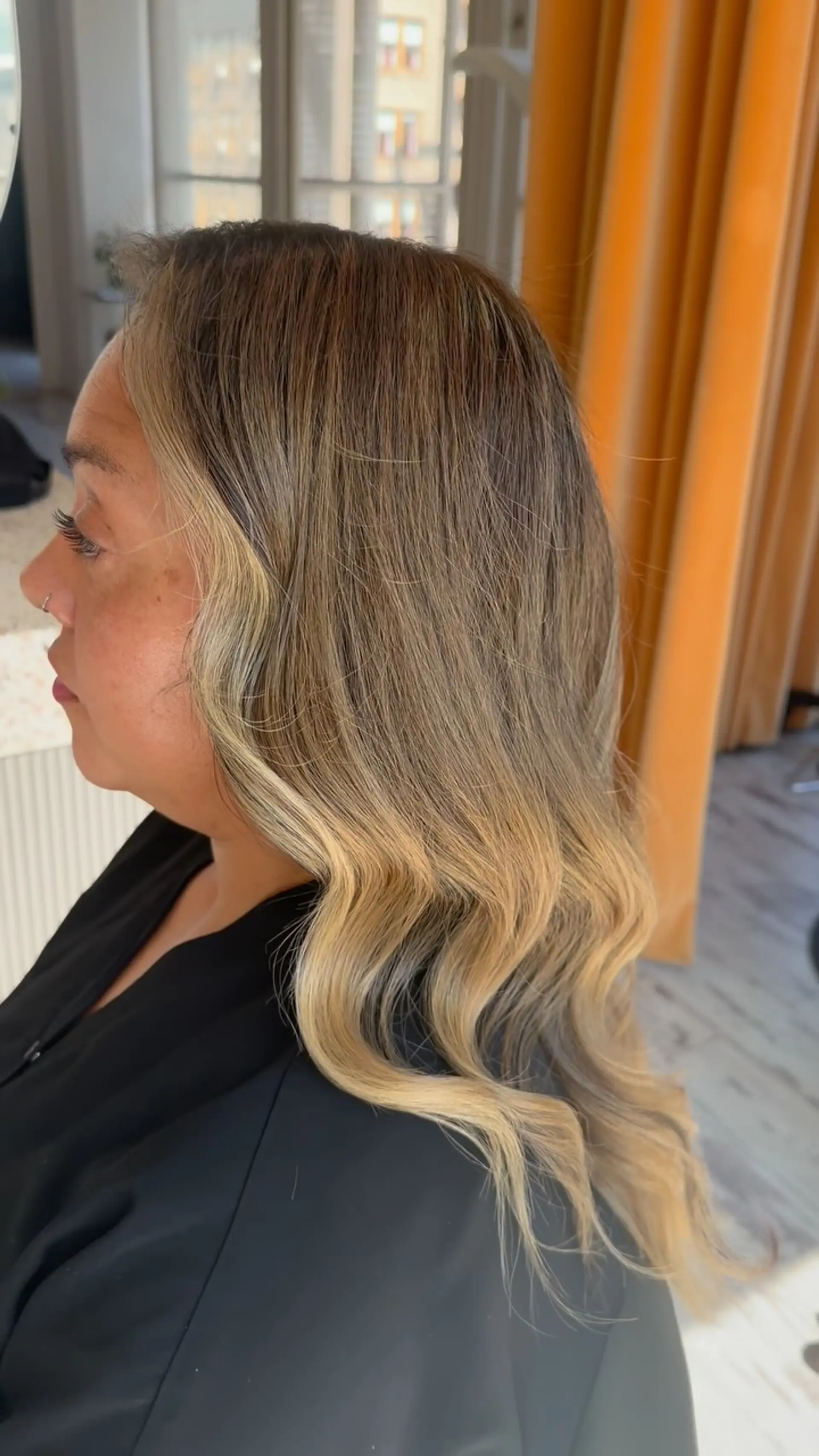 Long dimensional blonde balayage featuring a blend of warm and cool highlights styled into soft, elegant waves. 1