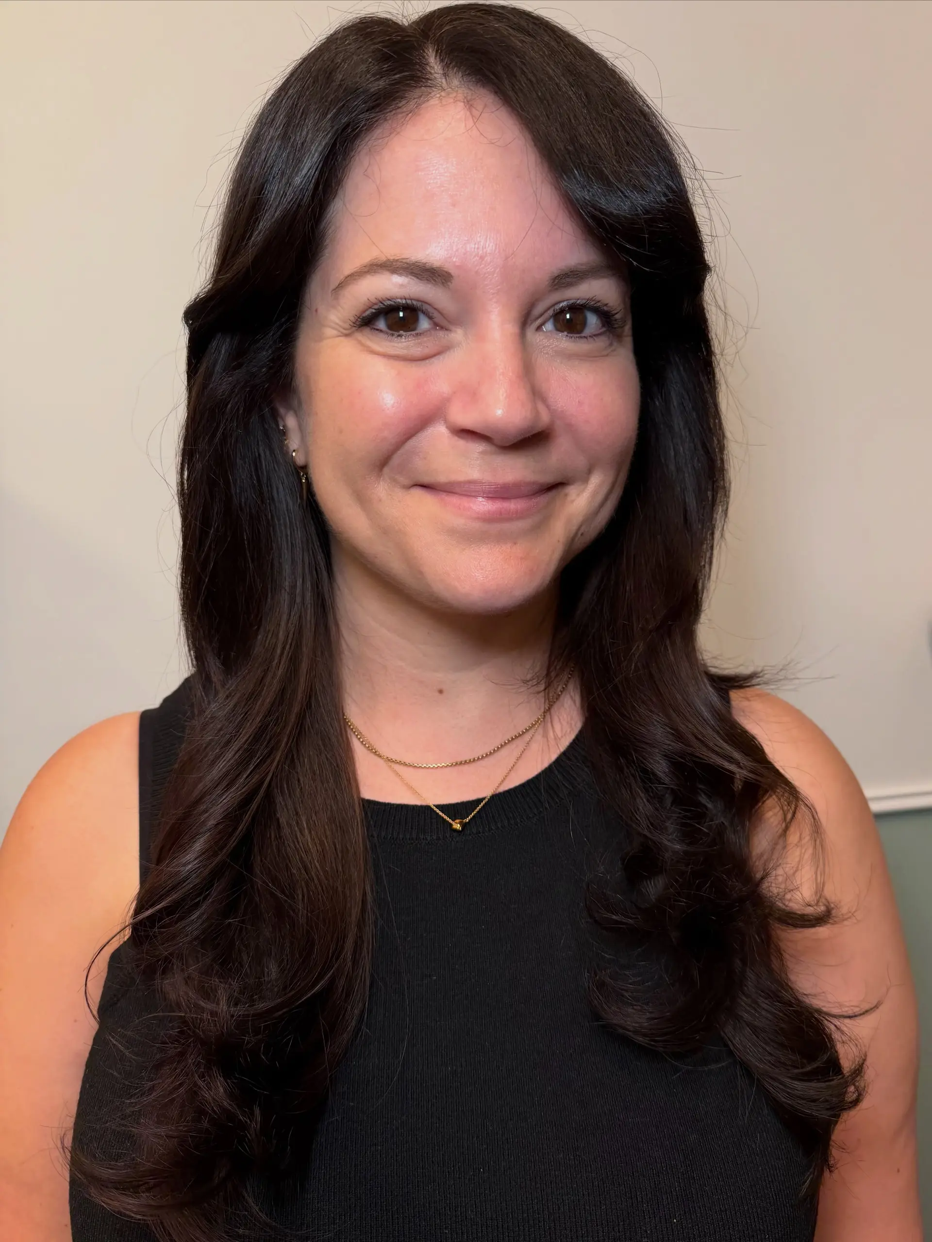 Rich, glossy dark brunette hair styled with soft, voluminous curls through the mid-lengths and ends. Current Gloss Toner/Finish option: $165 before tax. Gloss/toner and included finish only; haircut and lightening are not included. 1