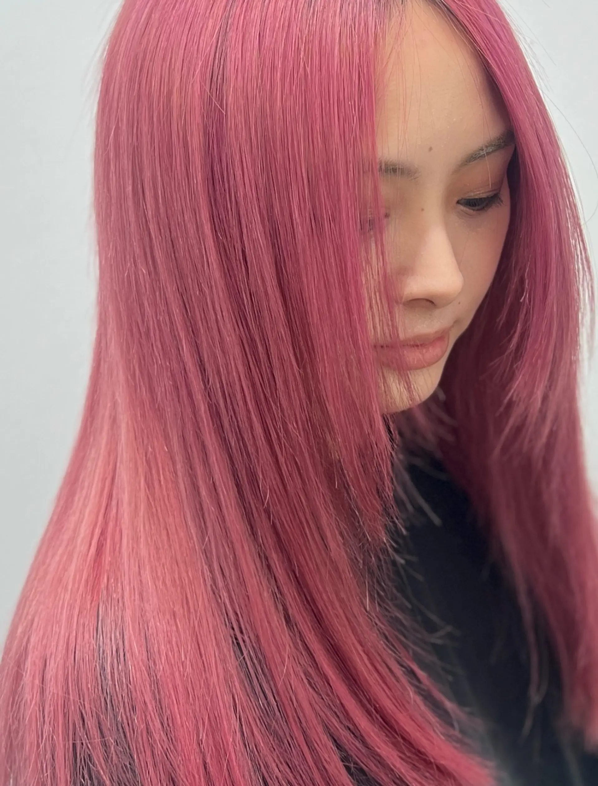 Vibrant dusty pink long straight hair styled smooth with soft face-framing layers. 1