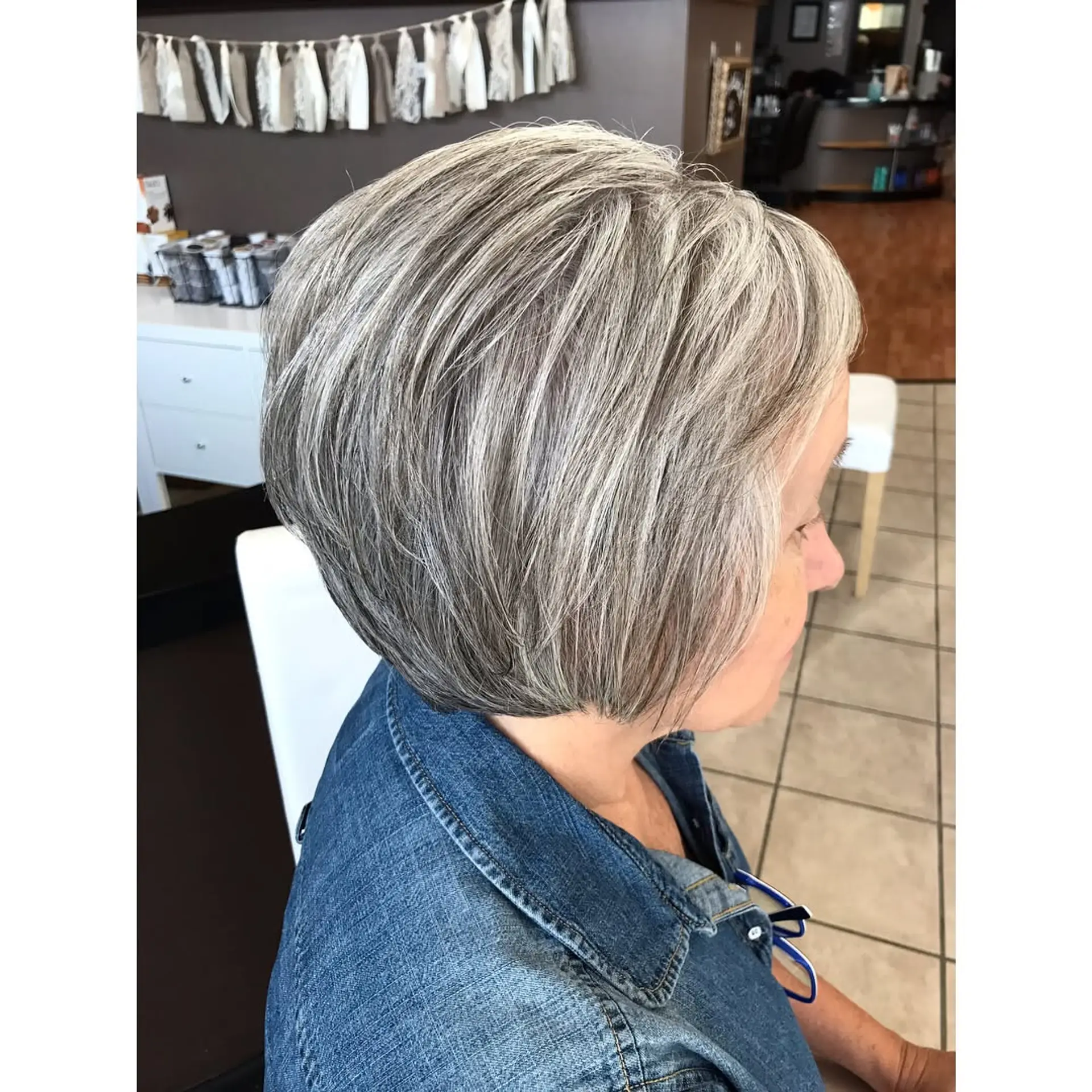 A sleek, rounded short bob cut featuring luminous silver and dimensional gray tones. 1