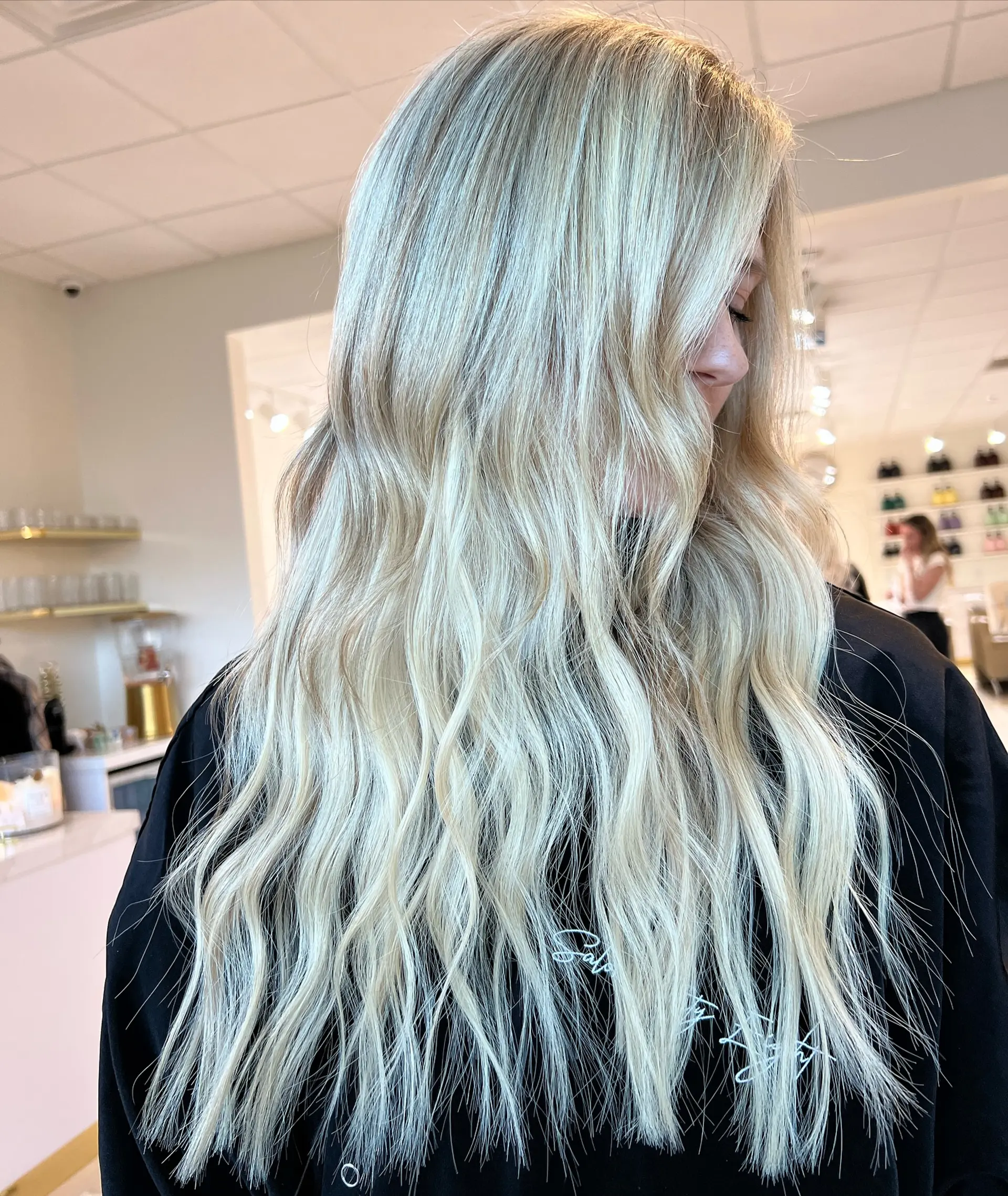Long cool-toned platinum blonde hair styled with soft, textured waves. 1