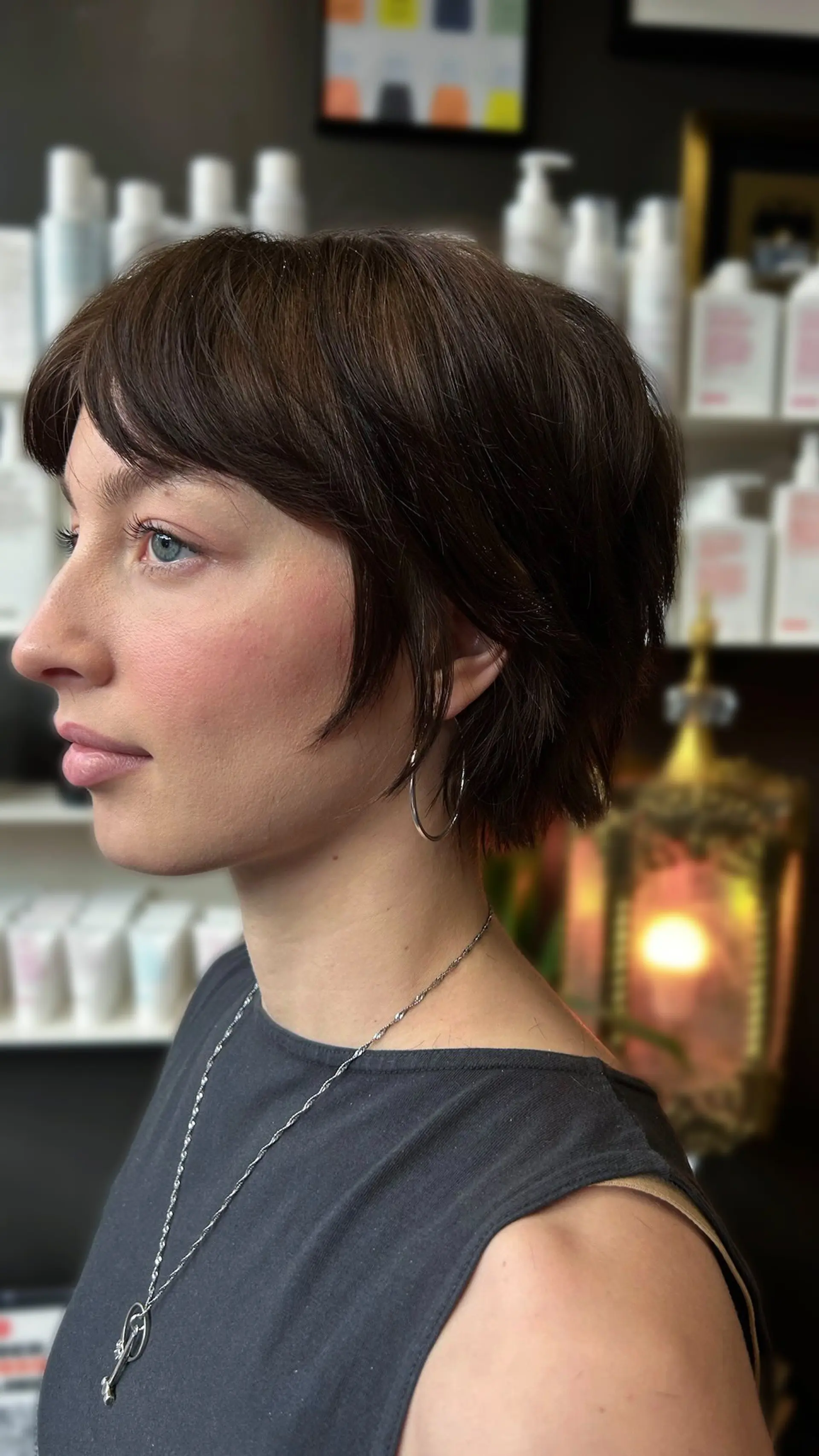 A textured bixie haircut featuring soft, piecey layers, face-framing fringe, and a tapered nape. 1