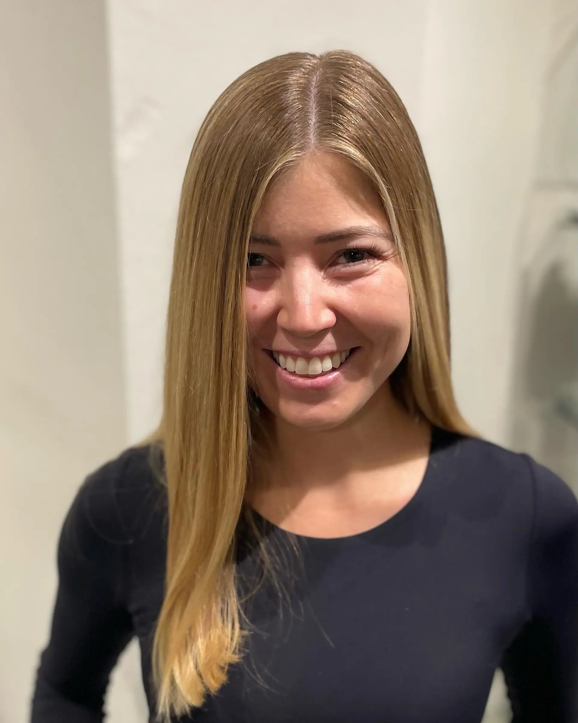 Long, sleek straight hair with a center part and seamlessly blended warm golden blonde balayage highlights. 1