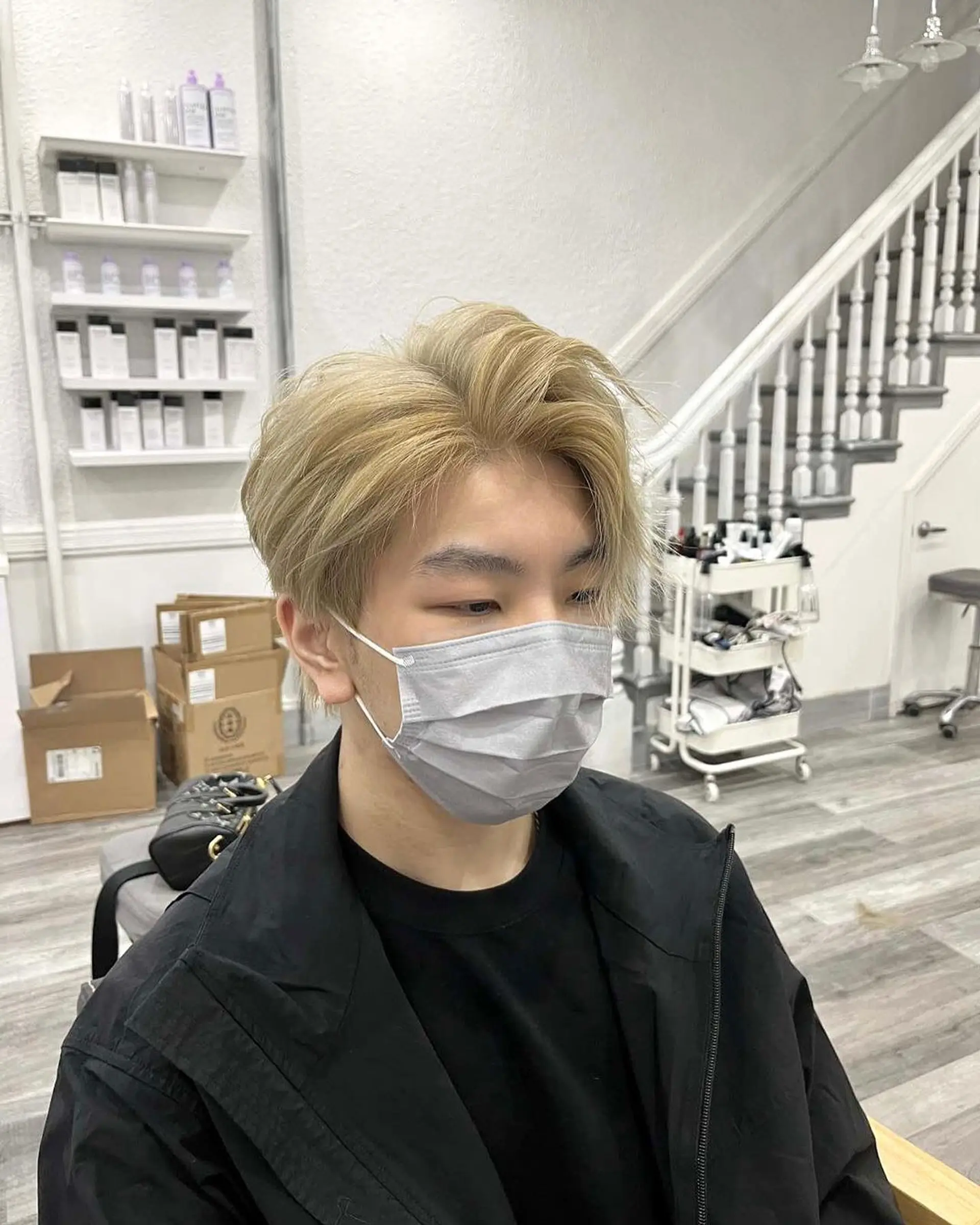 A medium-length wavy cut with a tousled, layered texture in a striking blonde shade, featuring a side part for a natural, effortless look. 1