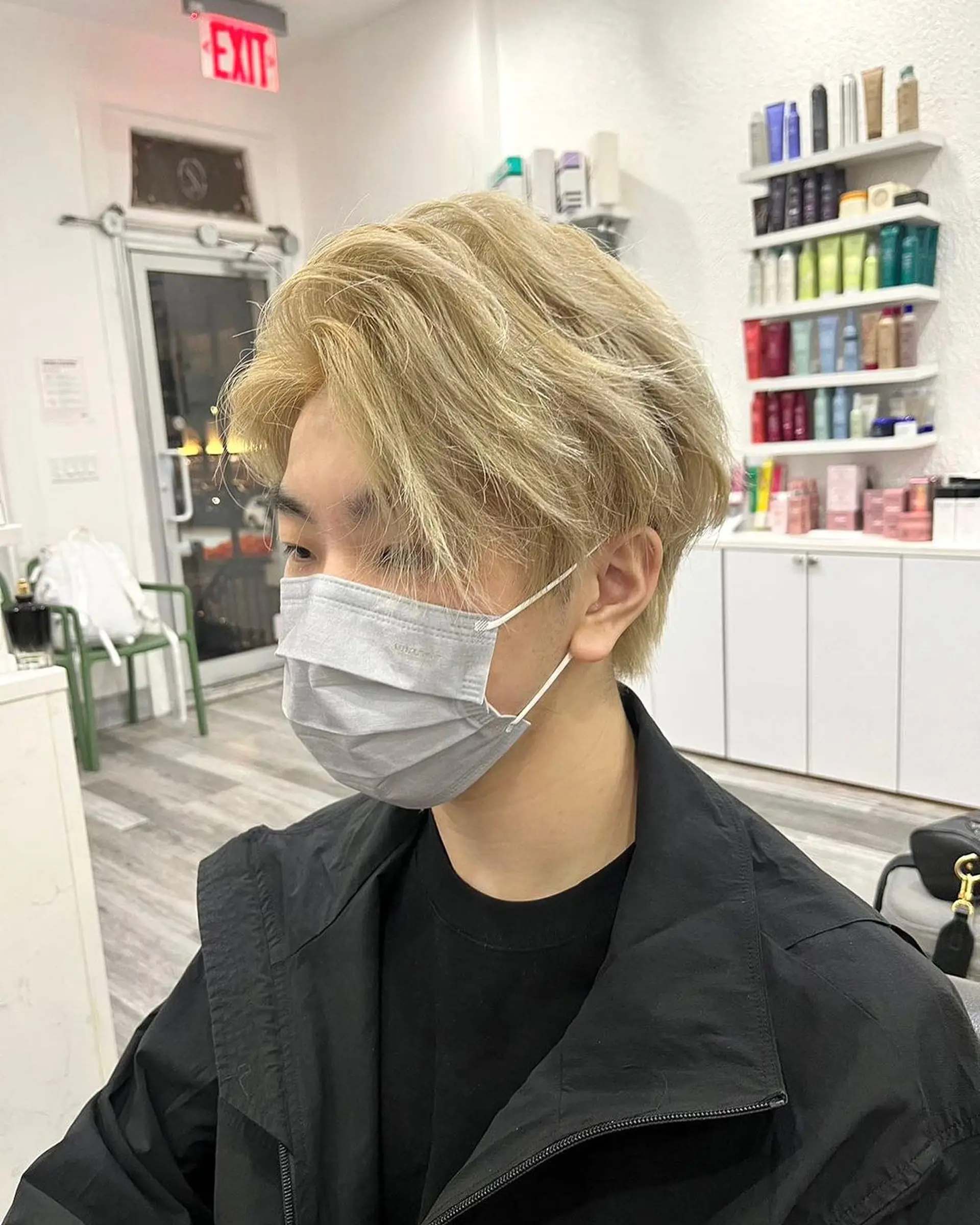 A medium-length wavy cut with a tousled, layered texture in a striking blonde shade, featuring a side part for a natural, effortless look. 2