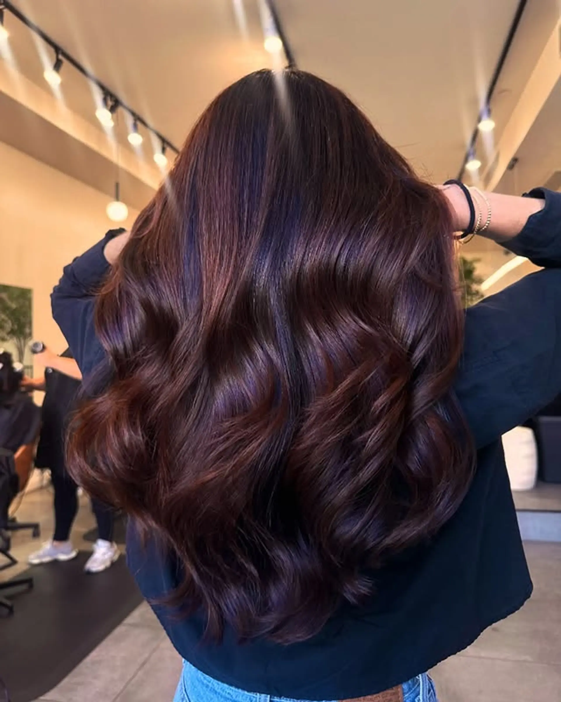 Long, wavy hair with chocolate brown and cherry-toned highlights. 1
