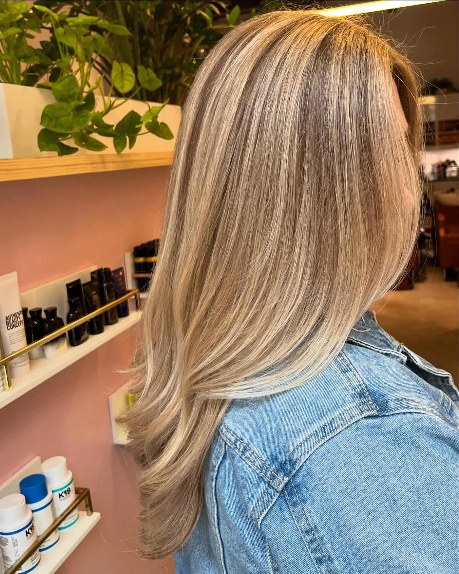 Dimensional blonde balayage over light brown tones, styled straight with soft curled-under ends and long layers. 1