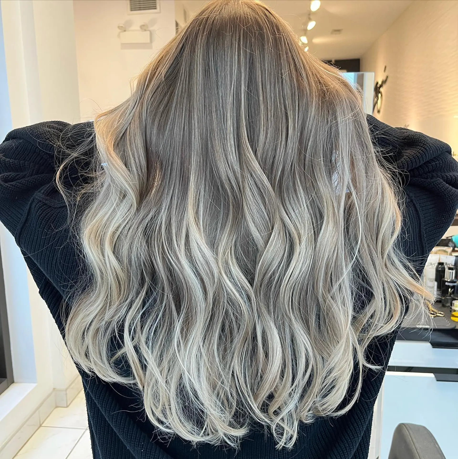 Long, wavy hair with an ash blonde balayage, creating a soft and beachy look. 1