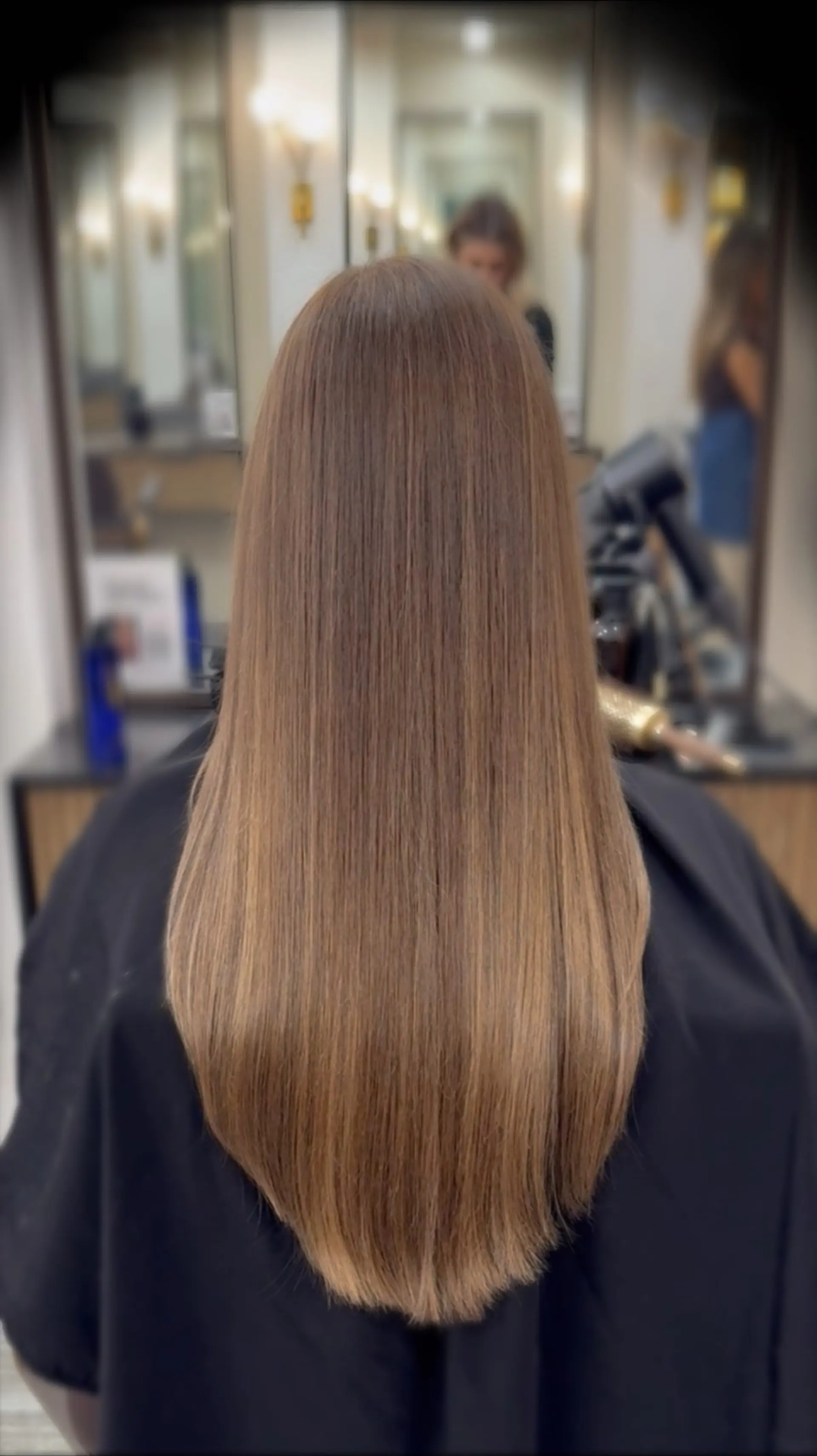Sleek, straight light brown hair styled with a smooth, glossy blowout and a soft curved hemline. 1