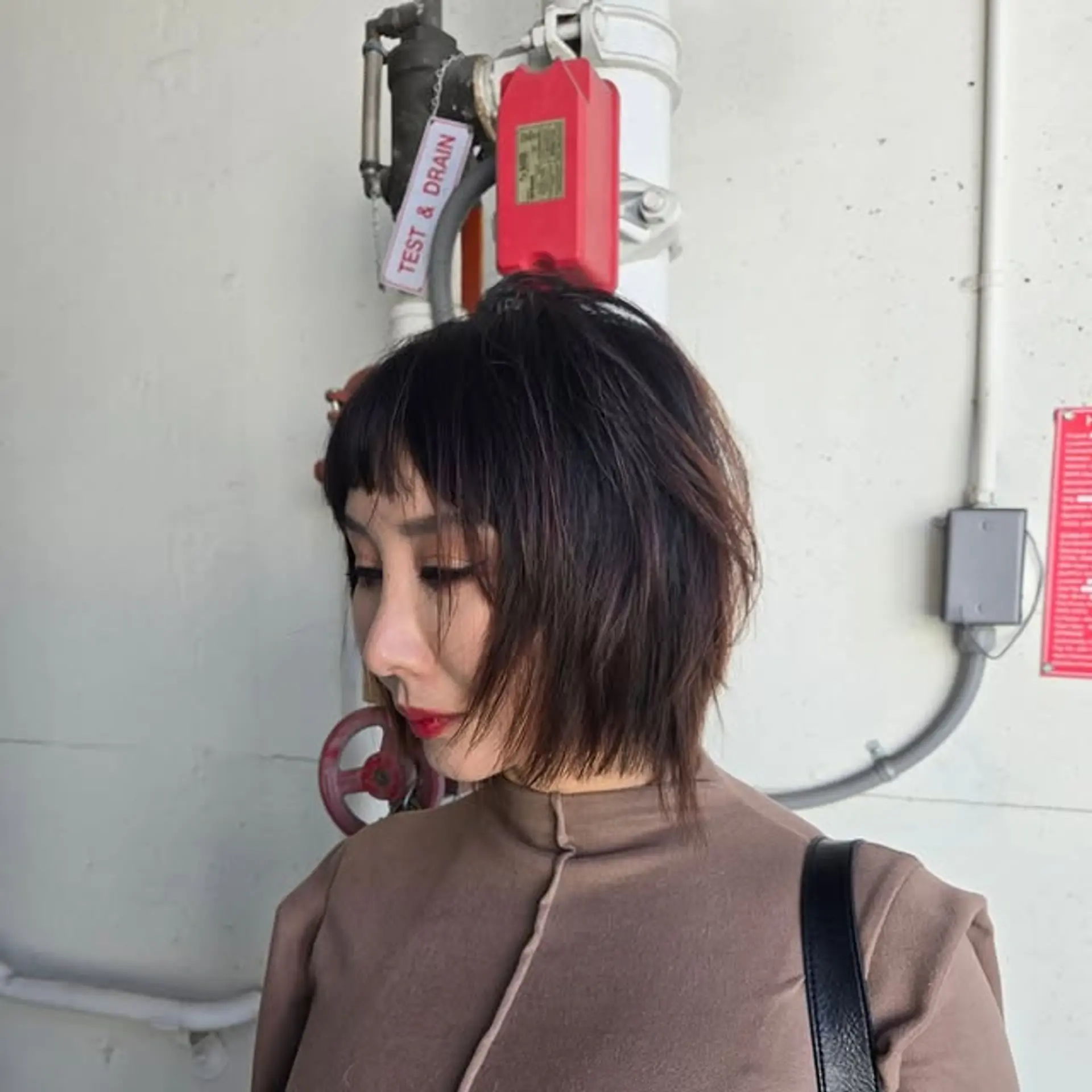 A trendy blunt bob with choppy layers and statement-making baby bangs. 1