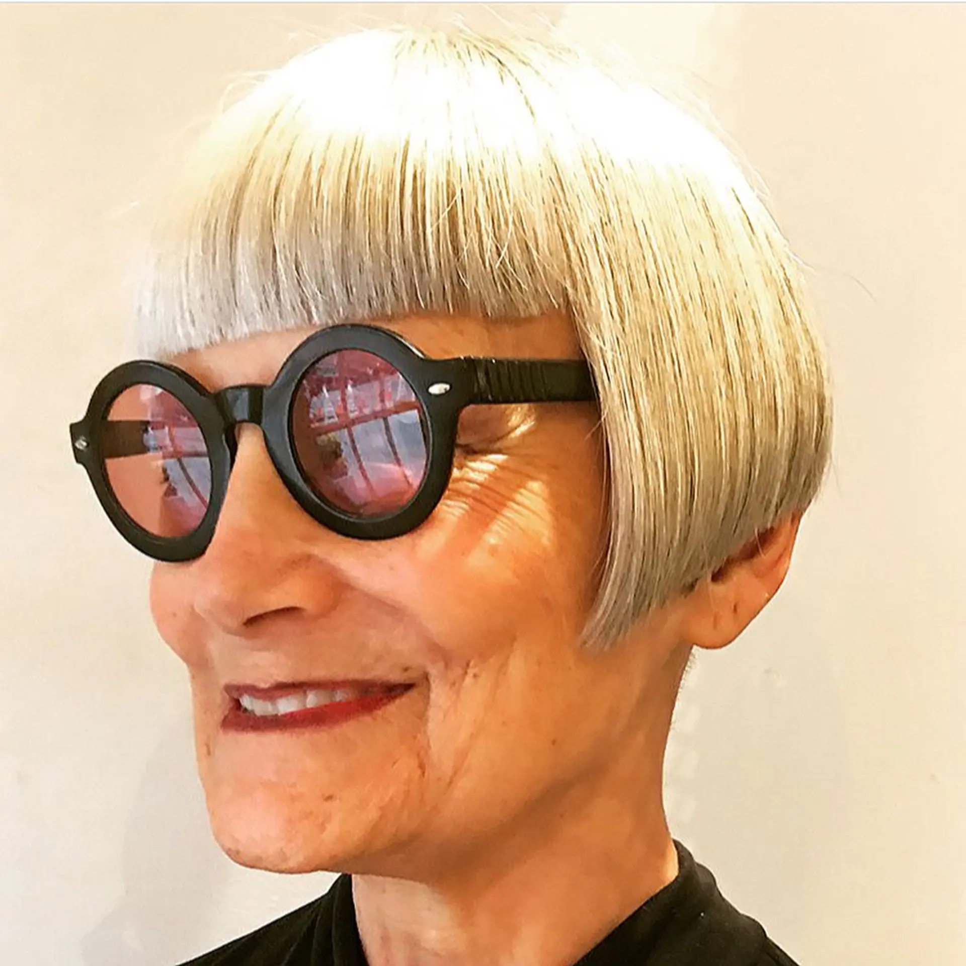 A classic short bob with a blunt fringe, featuring sleek, straight silver-grey hair that is chin-length and elegantly frames the face. 1