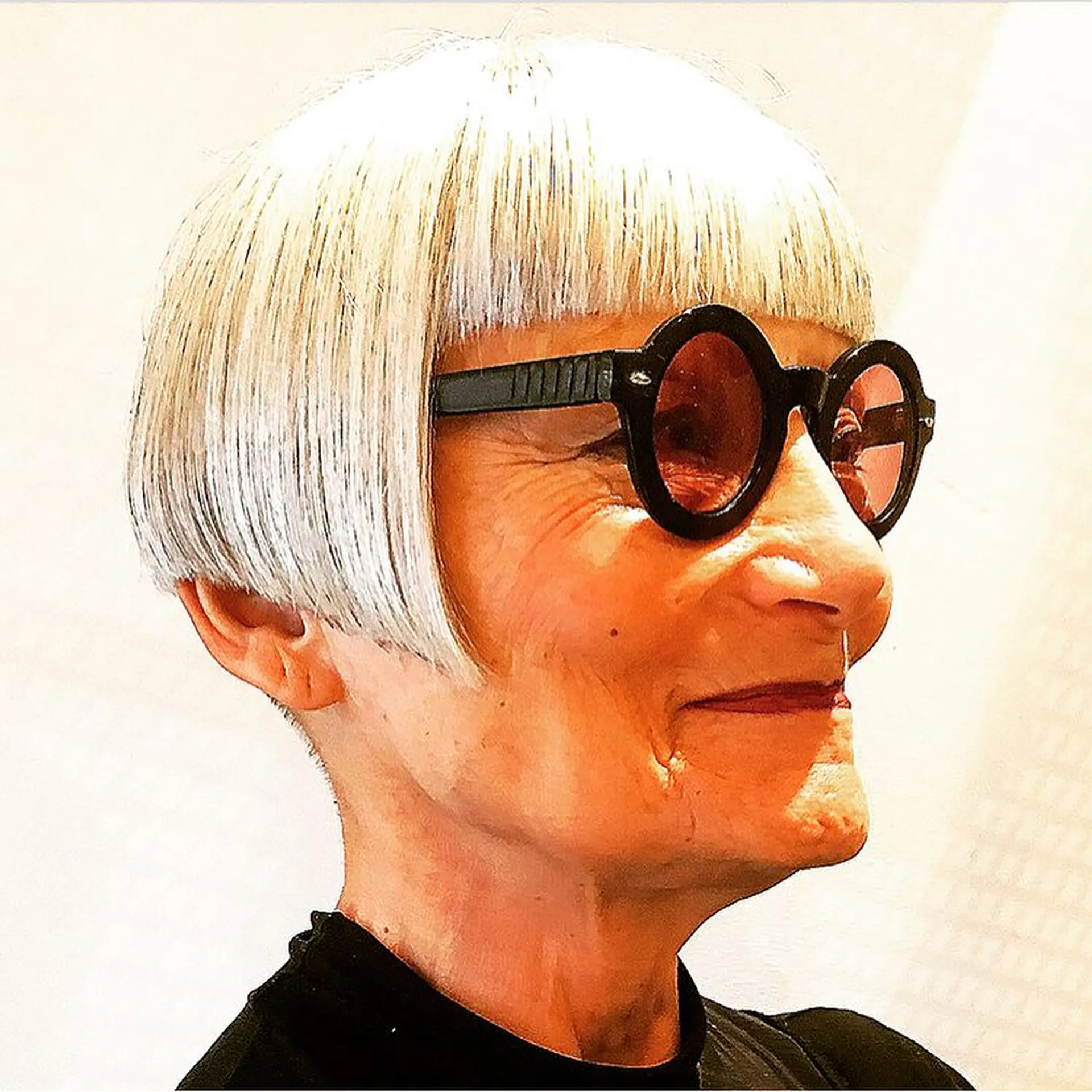 A classic short bob with a blunt fringe, featuring sleek, straight silver-grey hair that is chin-length and elegantly frames the face. 2