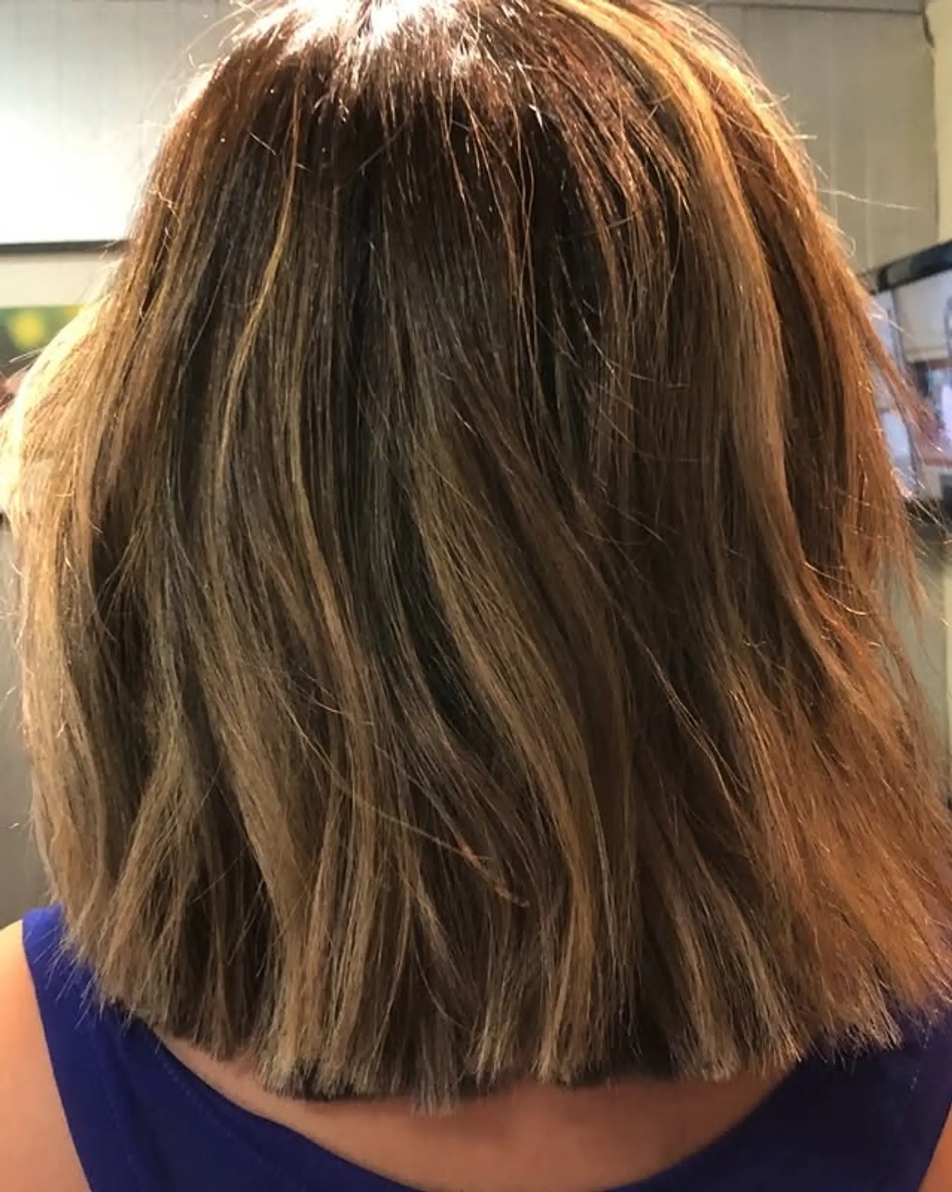 A layered bob with a mix of brown and blonde colors, creating a modern and stylish look. 1