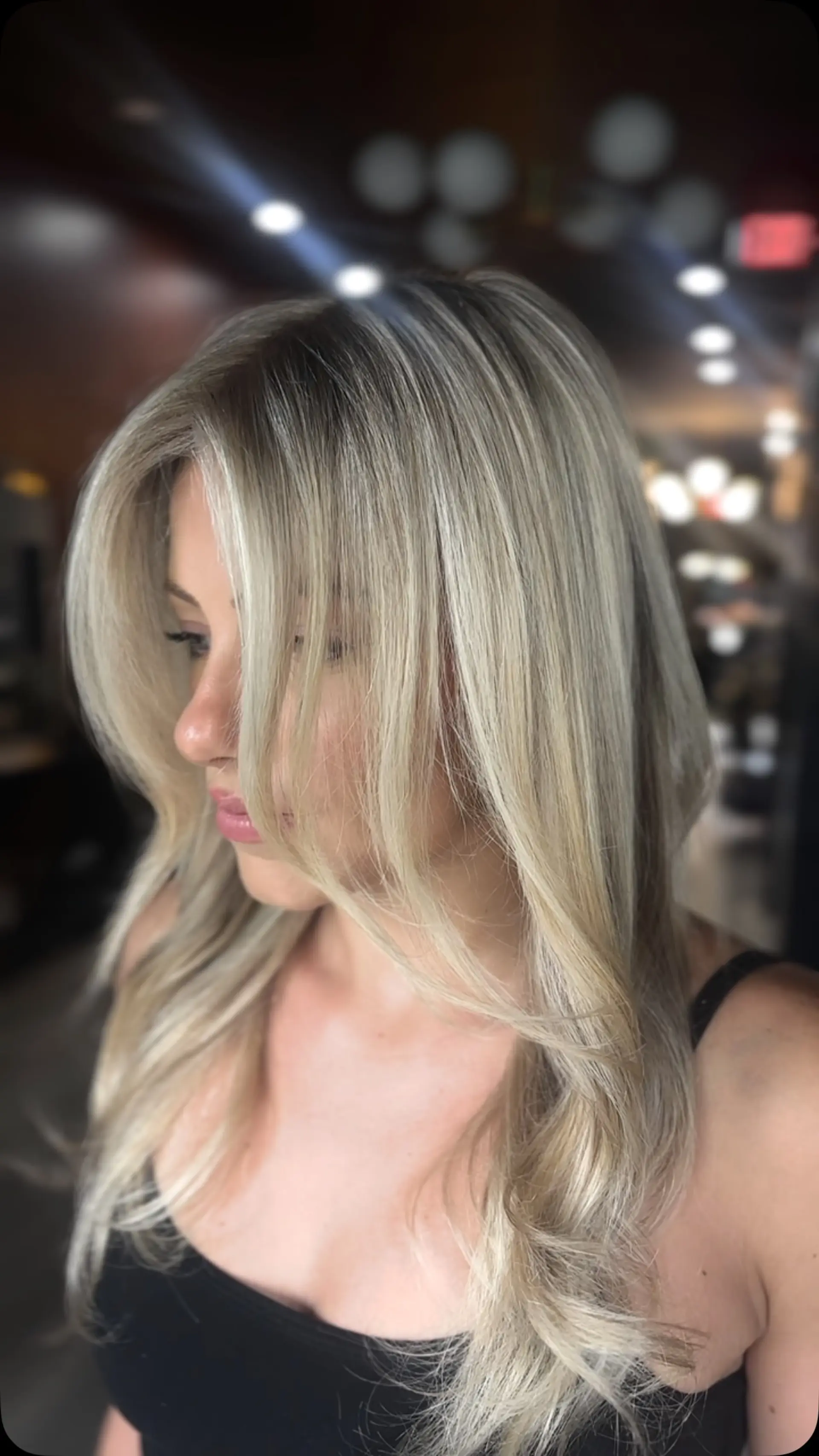 A seamless, dimensional blonde with fine highlights blended close to the root, paired with face-framing layers and a smooth blowout. 1