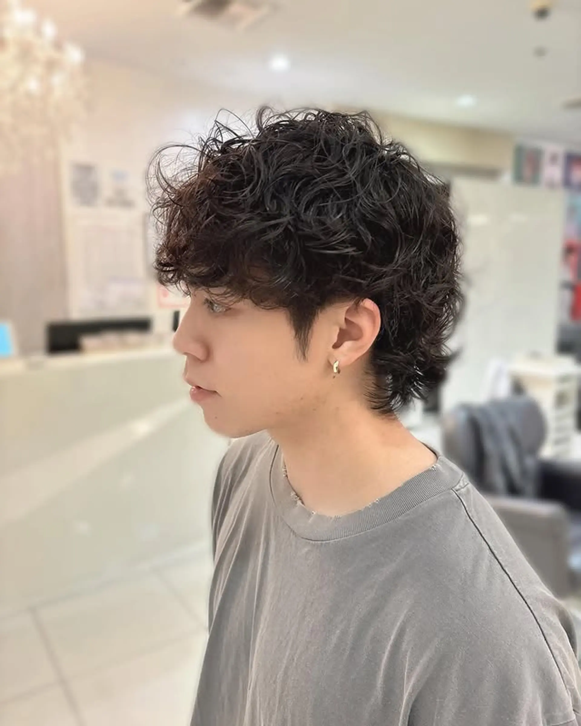 A trendy short mullet with a modern perm for a textured, curly look. 1