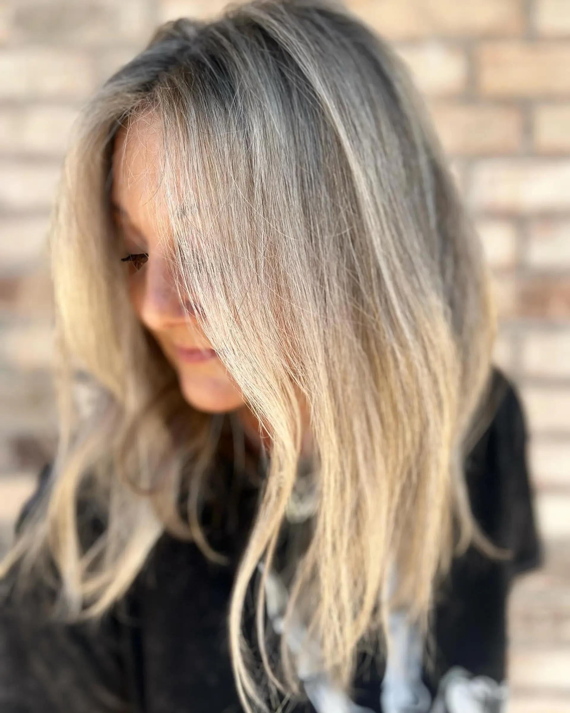 A textured medium-length lob featuring cool ash blonde dimensional highlights and soft face-framing layers. 1
