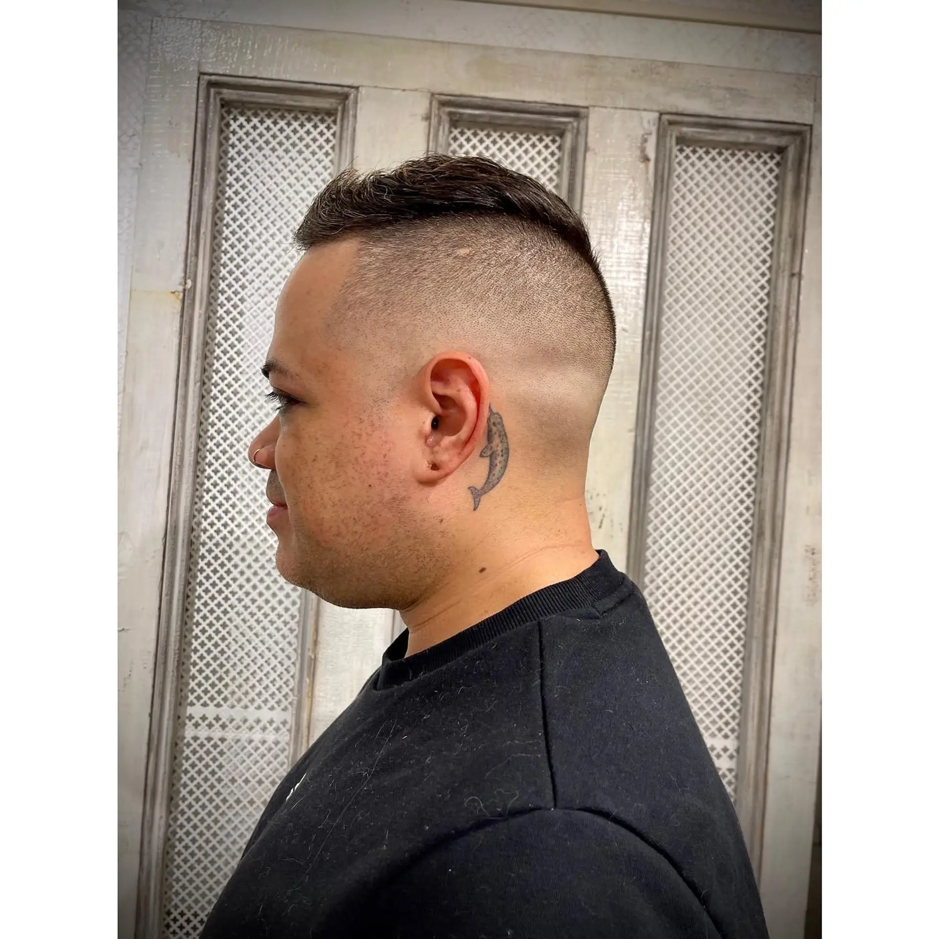 A sharp high skin fade paired with a cropped, textured short top. 1