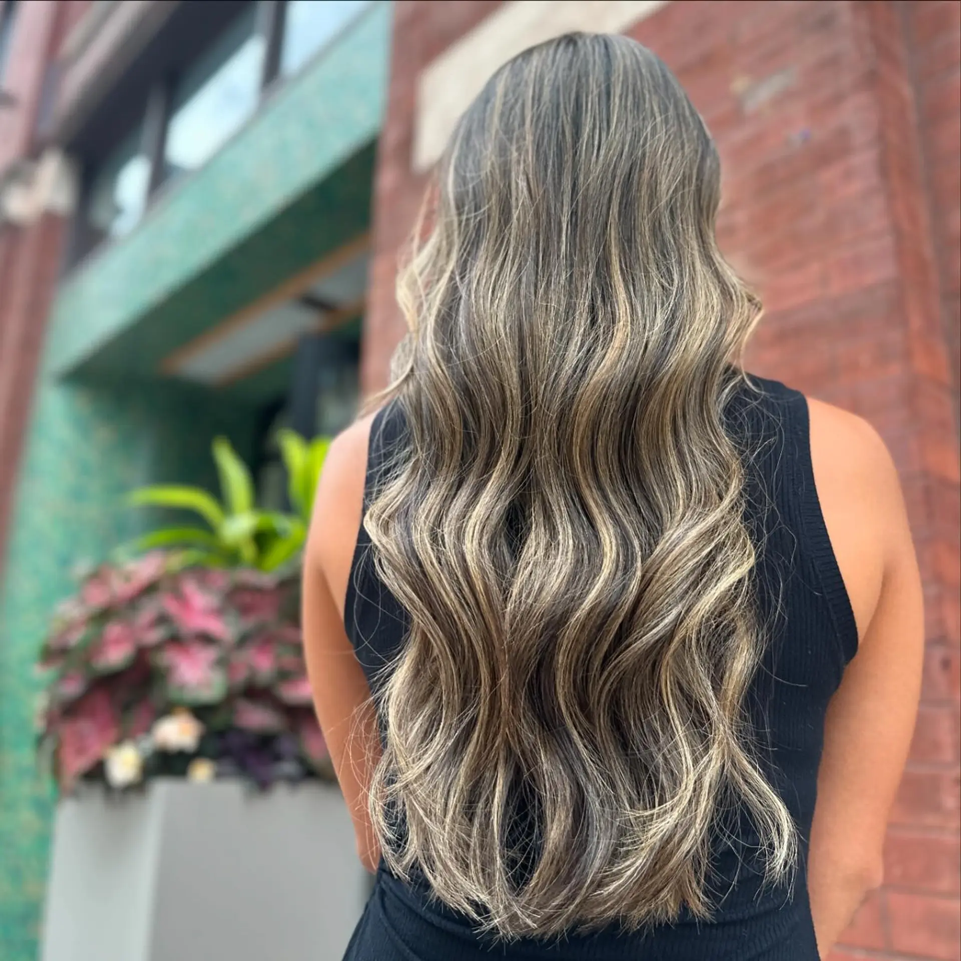 A long, wavy bronde balayage with seamless color transition. 1