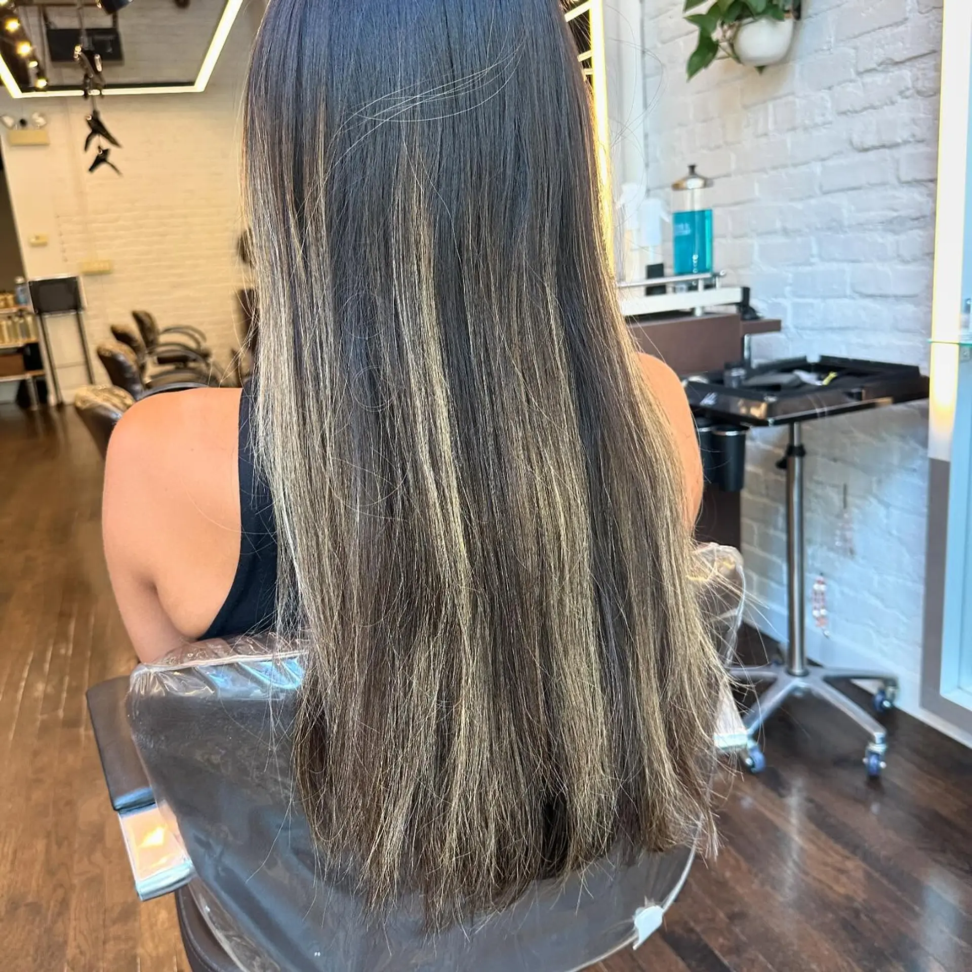 A long, wavy bronde balayage with seamless color transition. 2
