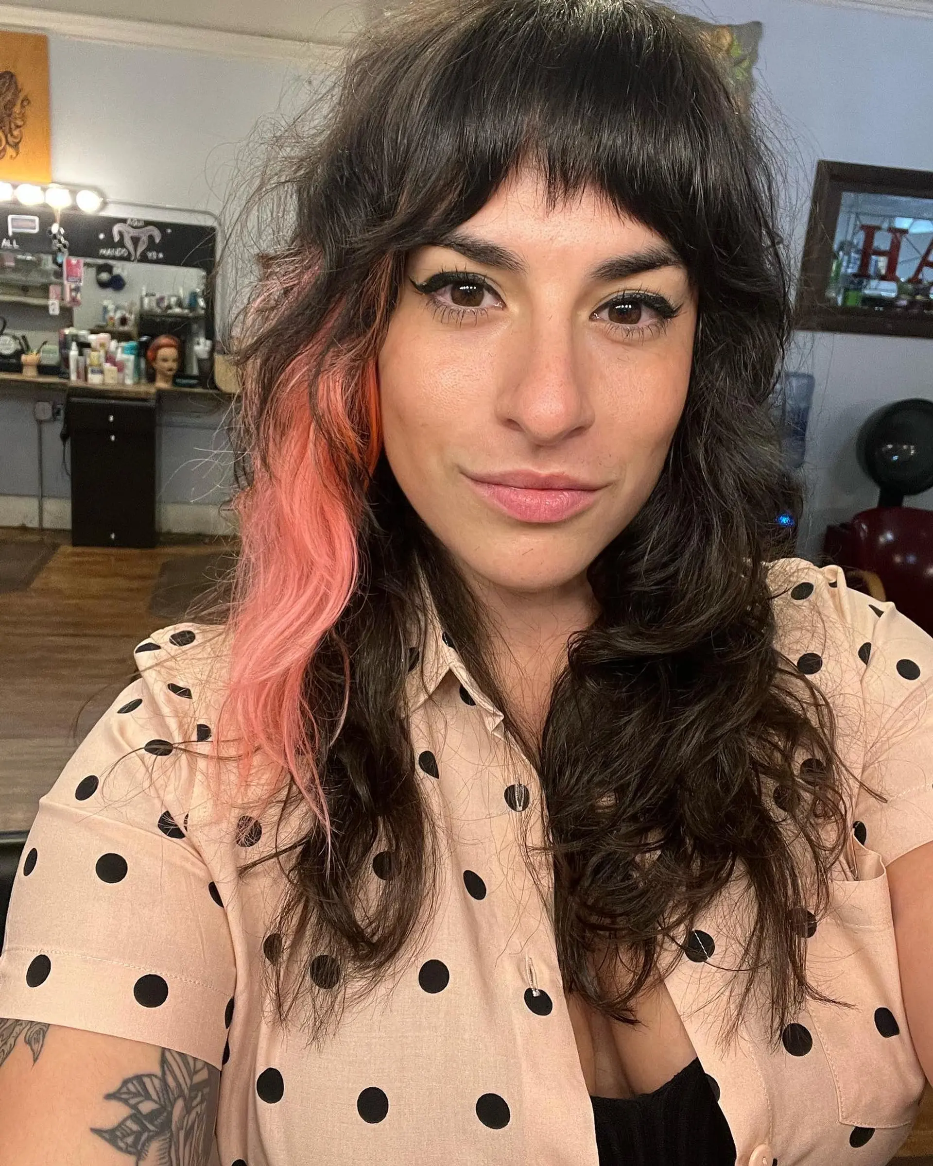 A choppy, medium-length shag with face-framing bangs and vibrant pink highlights. 2