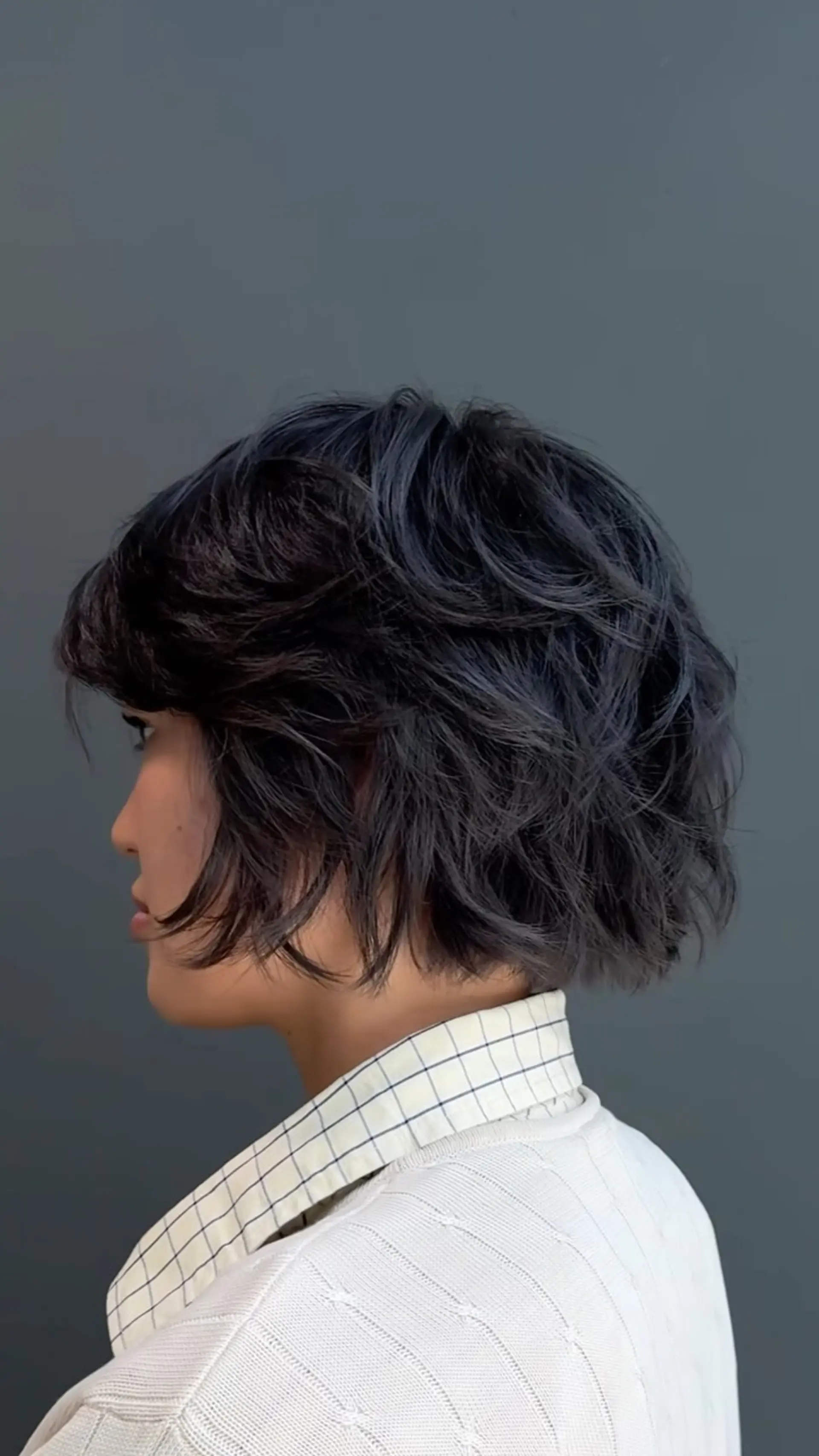 A textured, chin-length layered bixie cut with wispy, face-framing pieces and natural soft volume. 1