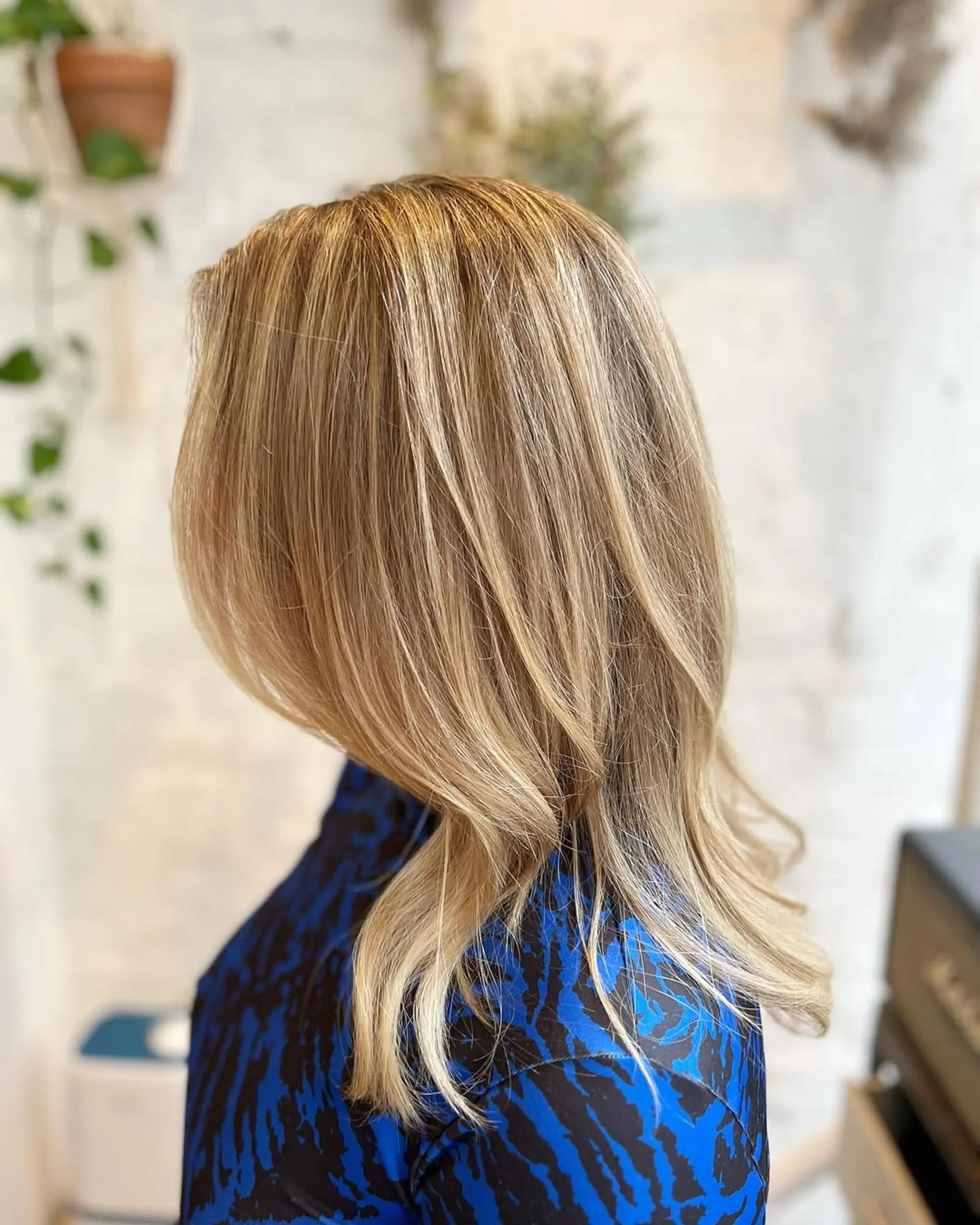 A beachy blonde balayage lob with soft waves. 3