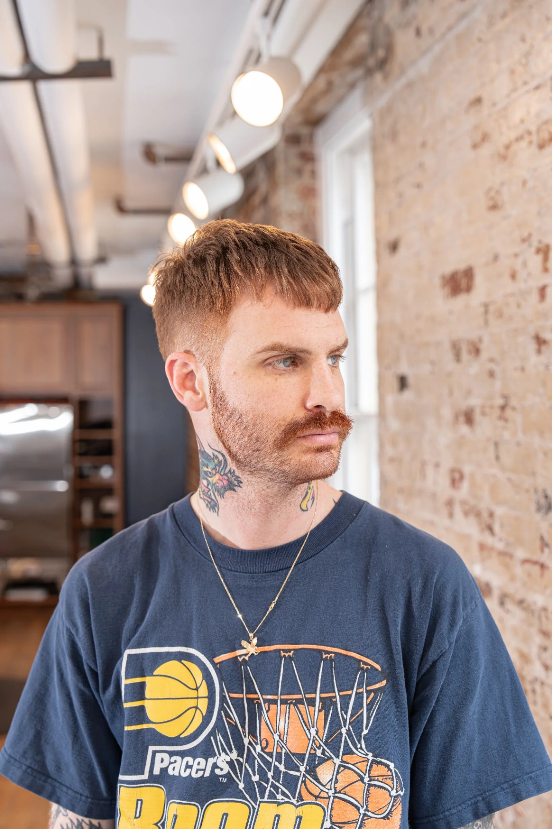 A man with a modern textured crop haircut with subtle ash blonde highlights, a key hair trend for 2025. - Preview 3