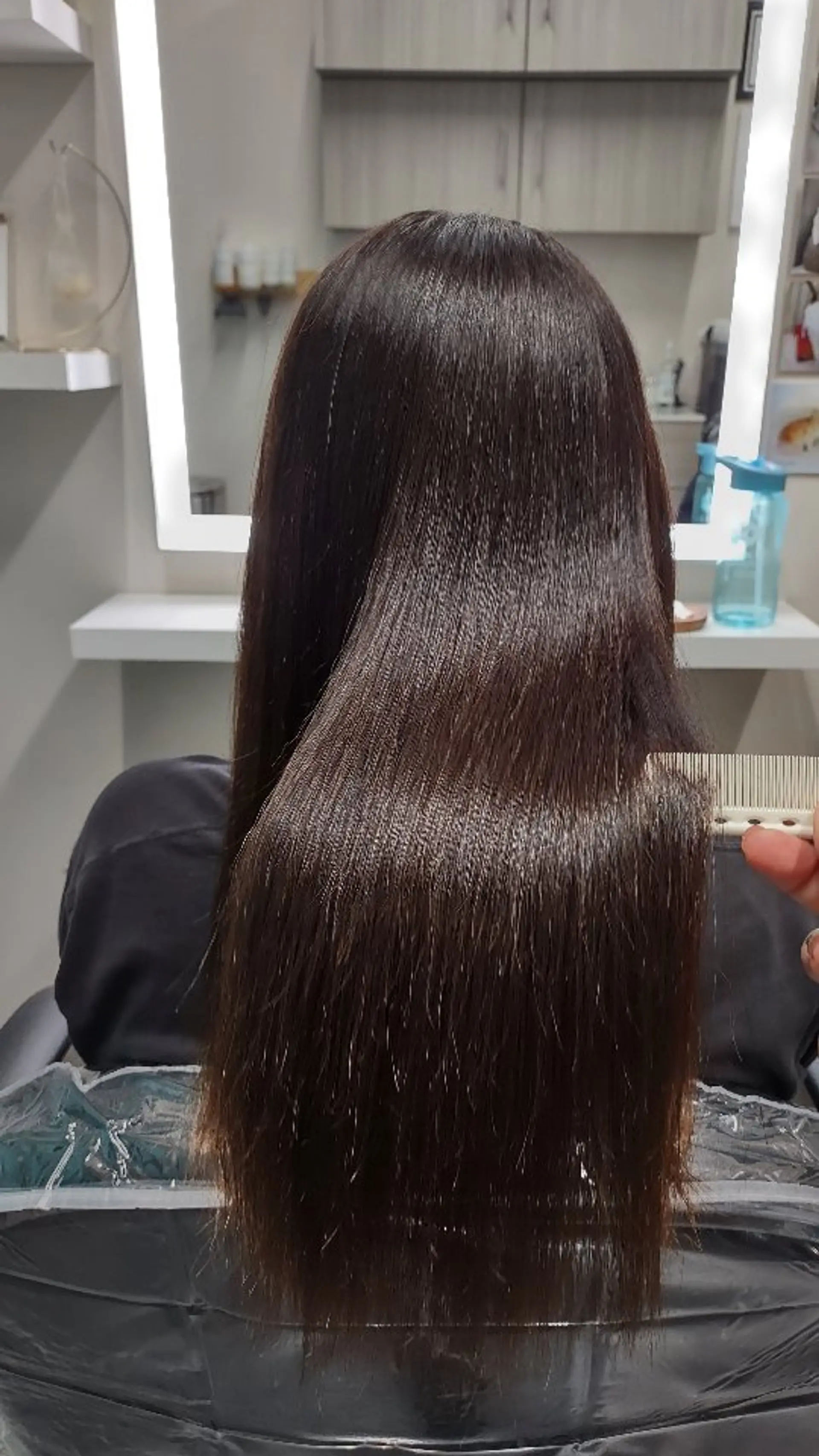 Ultra-sleek, pin-straight dark brown hair combed smooth with a radiant, high-shine finish. 1