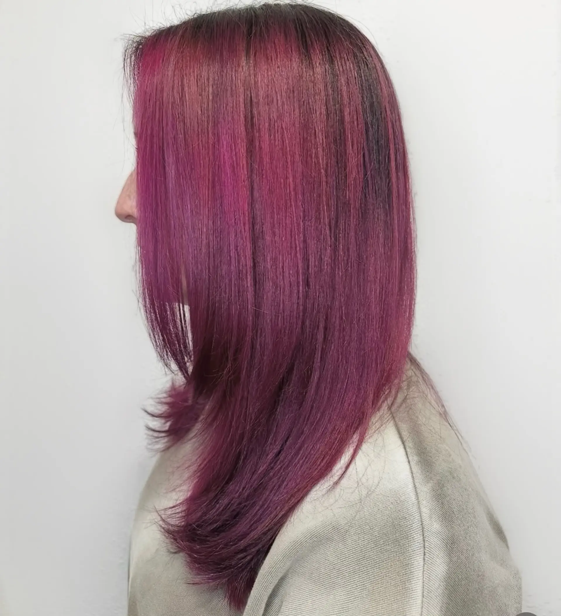 A sleek, shoulder-length straight hairstyle featuring a vibrant magenta and deep plum fantasy color with soft face-framing layers. 1