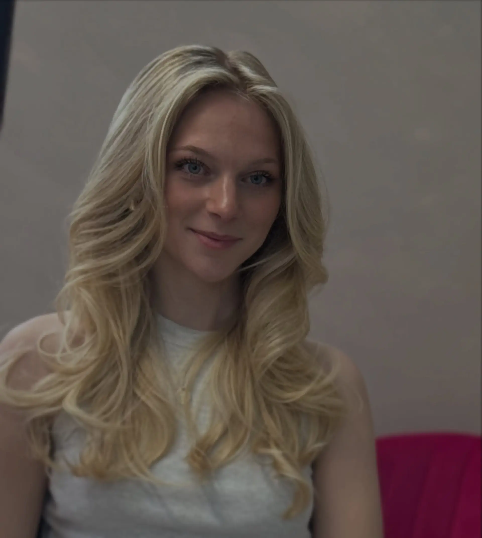 A voluminous long blonde blowout styled with feathered face-framing layers and soft curls. 1