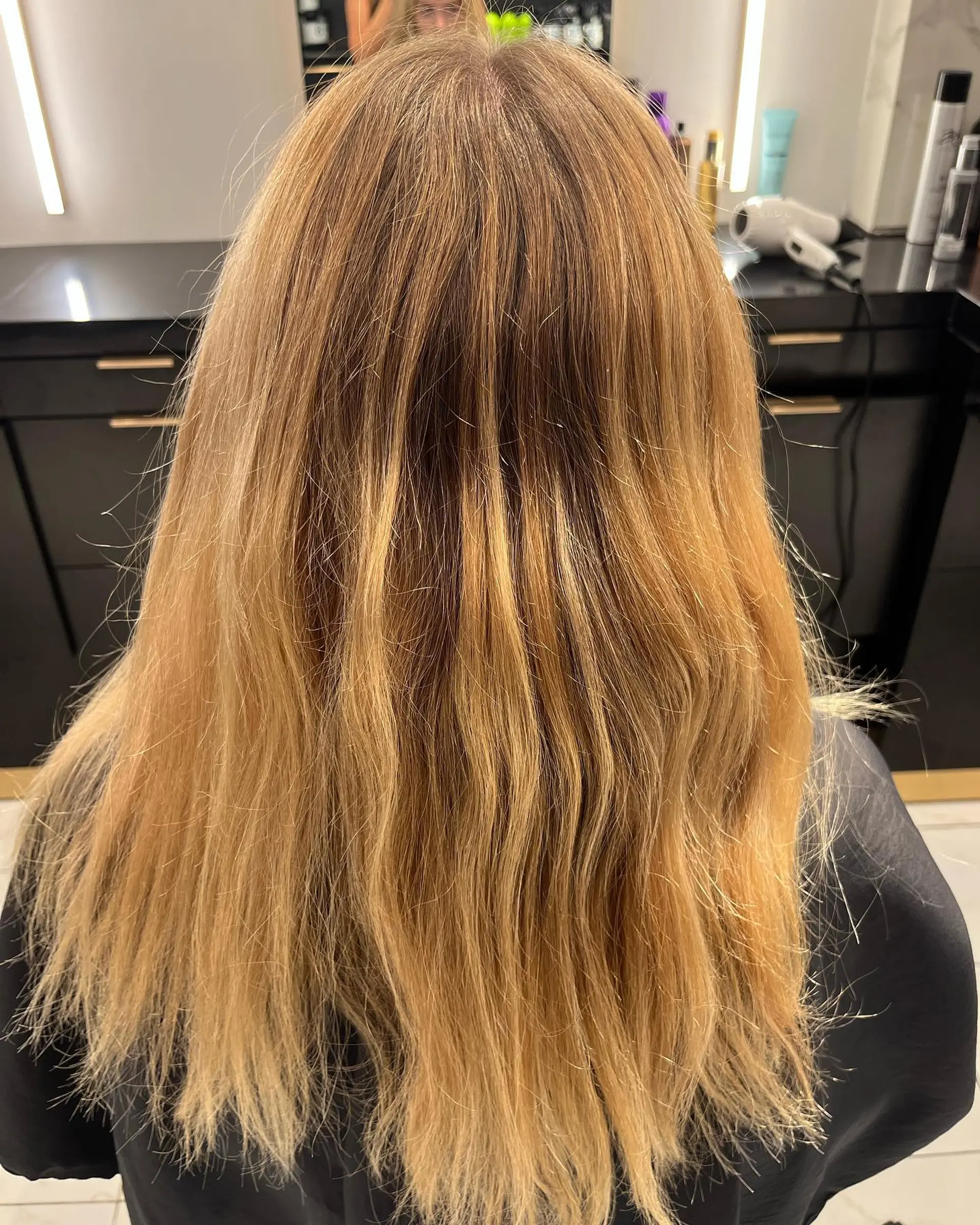Long, wavy hair with a blonde balayage. 2