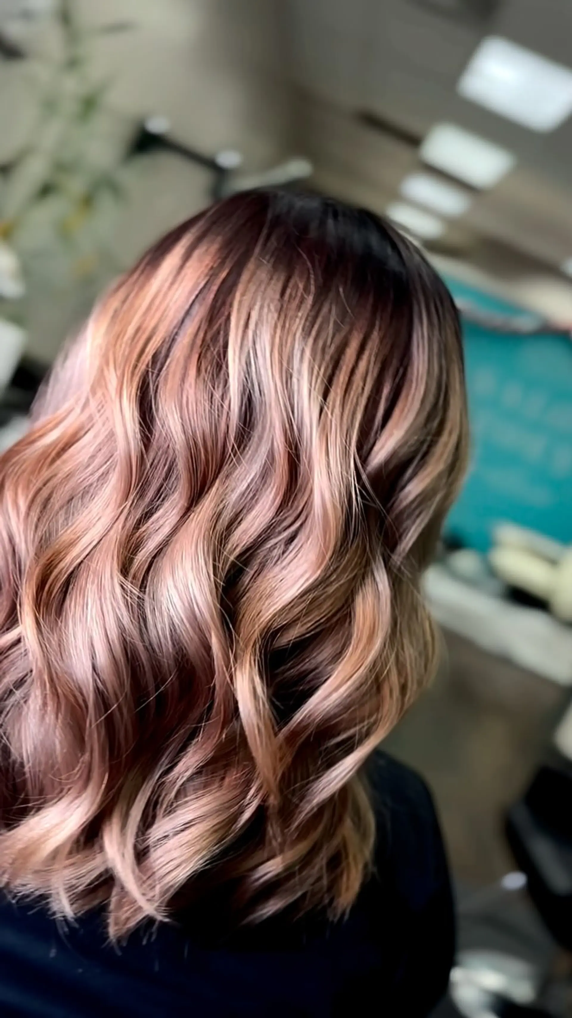Medium-length dimensional hair featuring an ash-toned balayage seamlessly blended from a dark base and styled into glossy, loose waves. 1