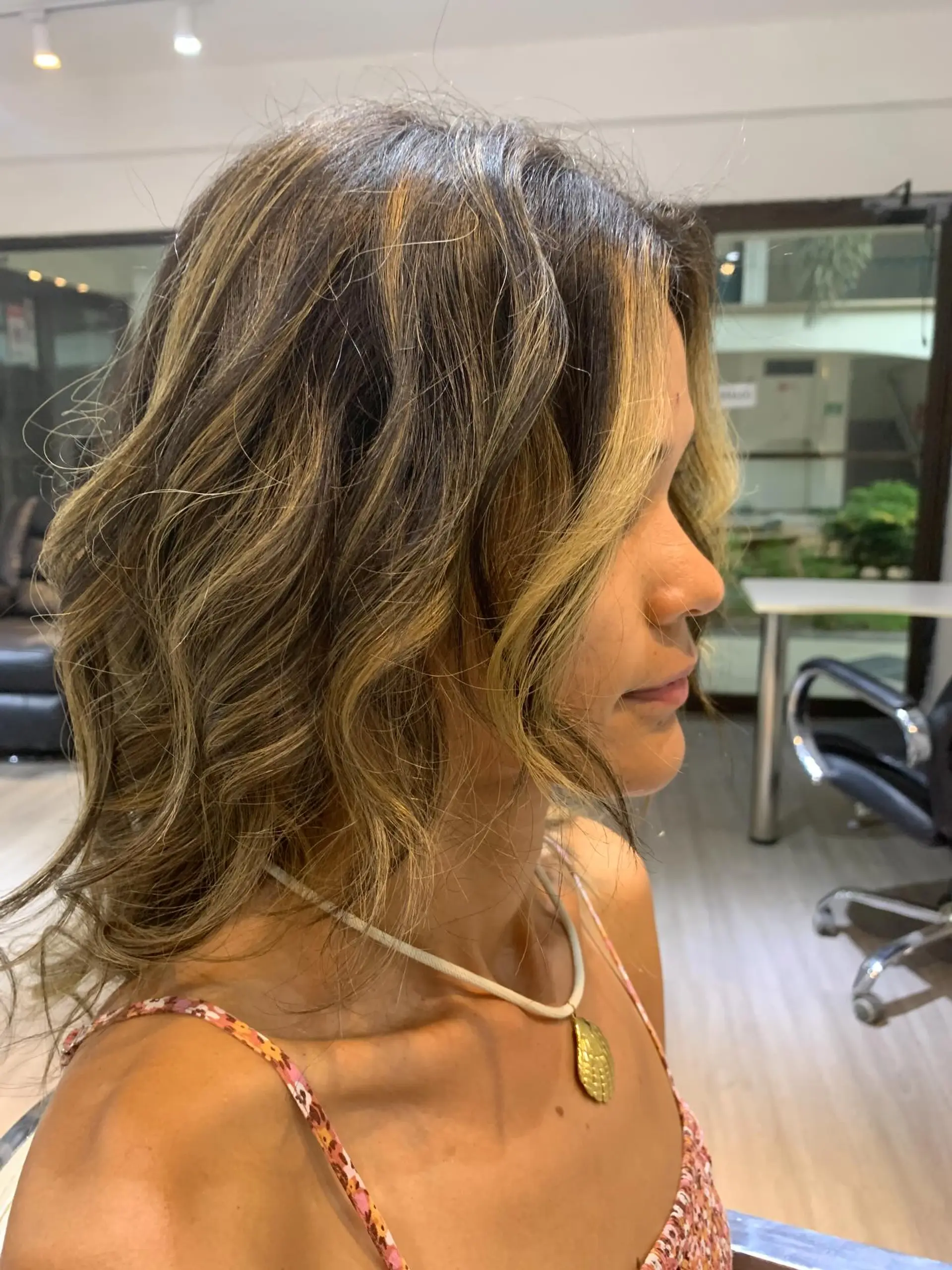 A textured medium-length wavy hairstyle with a dark brown base and bright face-framing blonde highlights. 1
