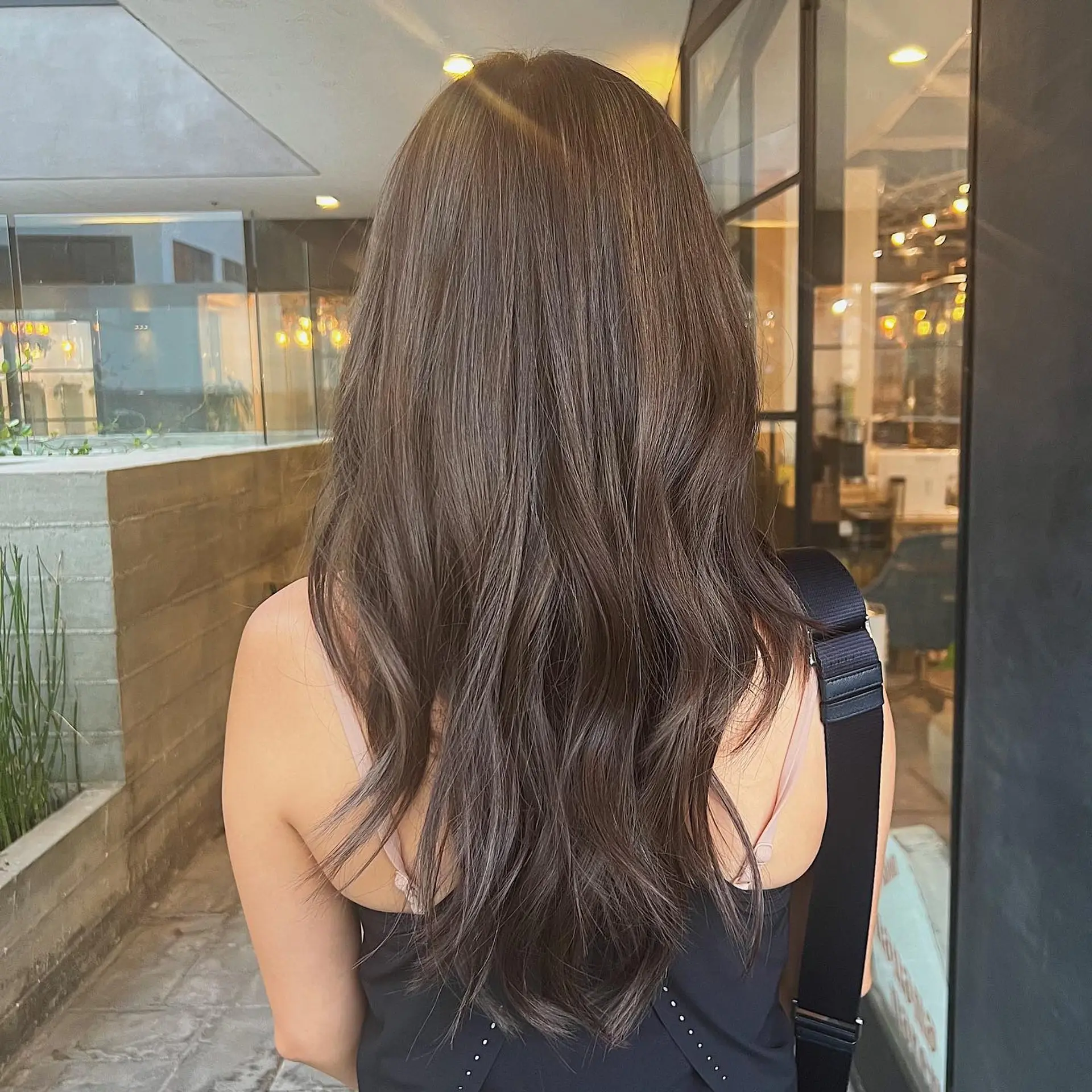Long, wavy hair with dimensional brunette color and soft waves. 1