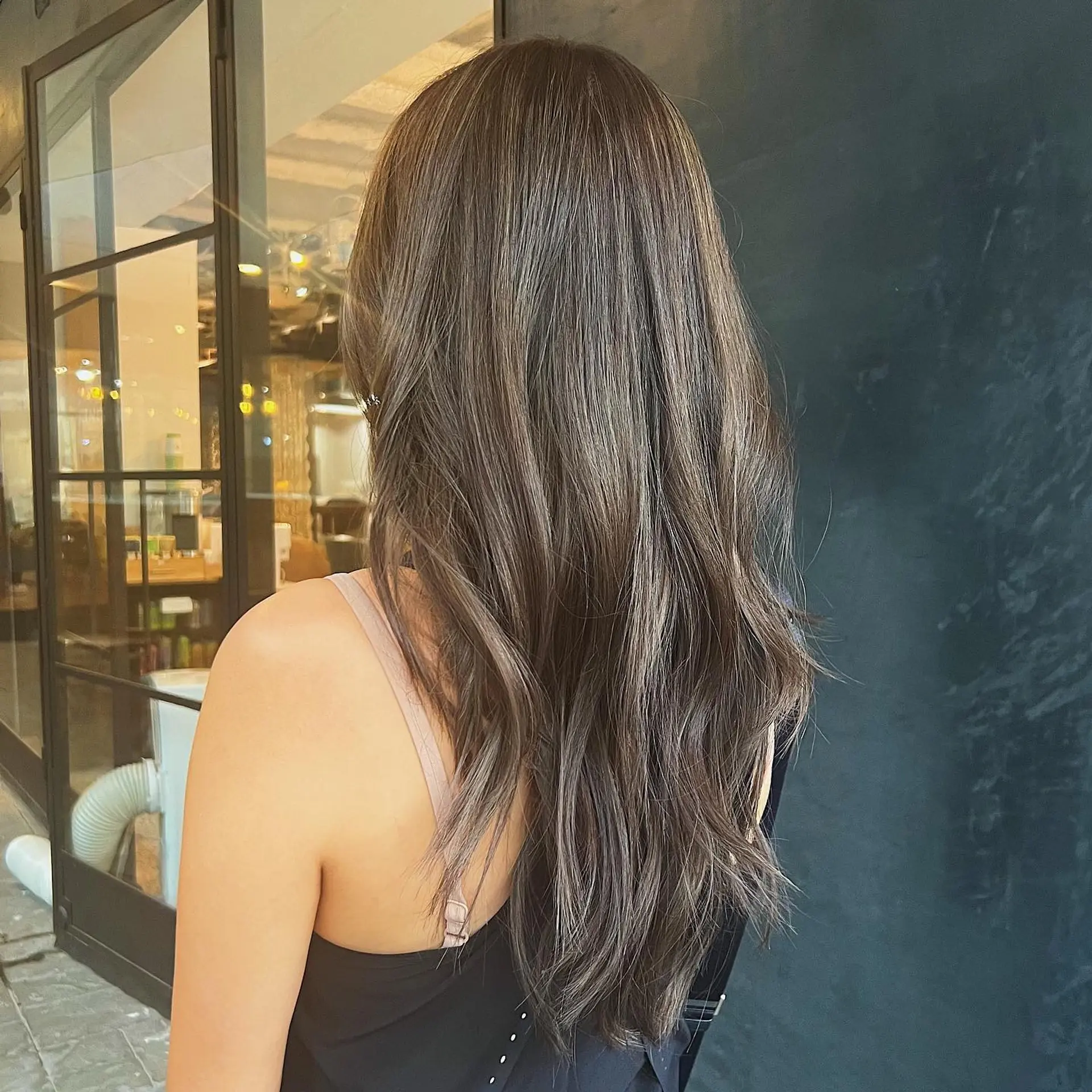 Long, wavy hair with dimensional brunette color and soft waves. 2