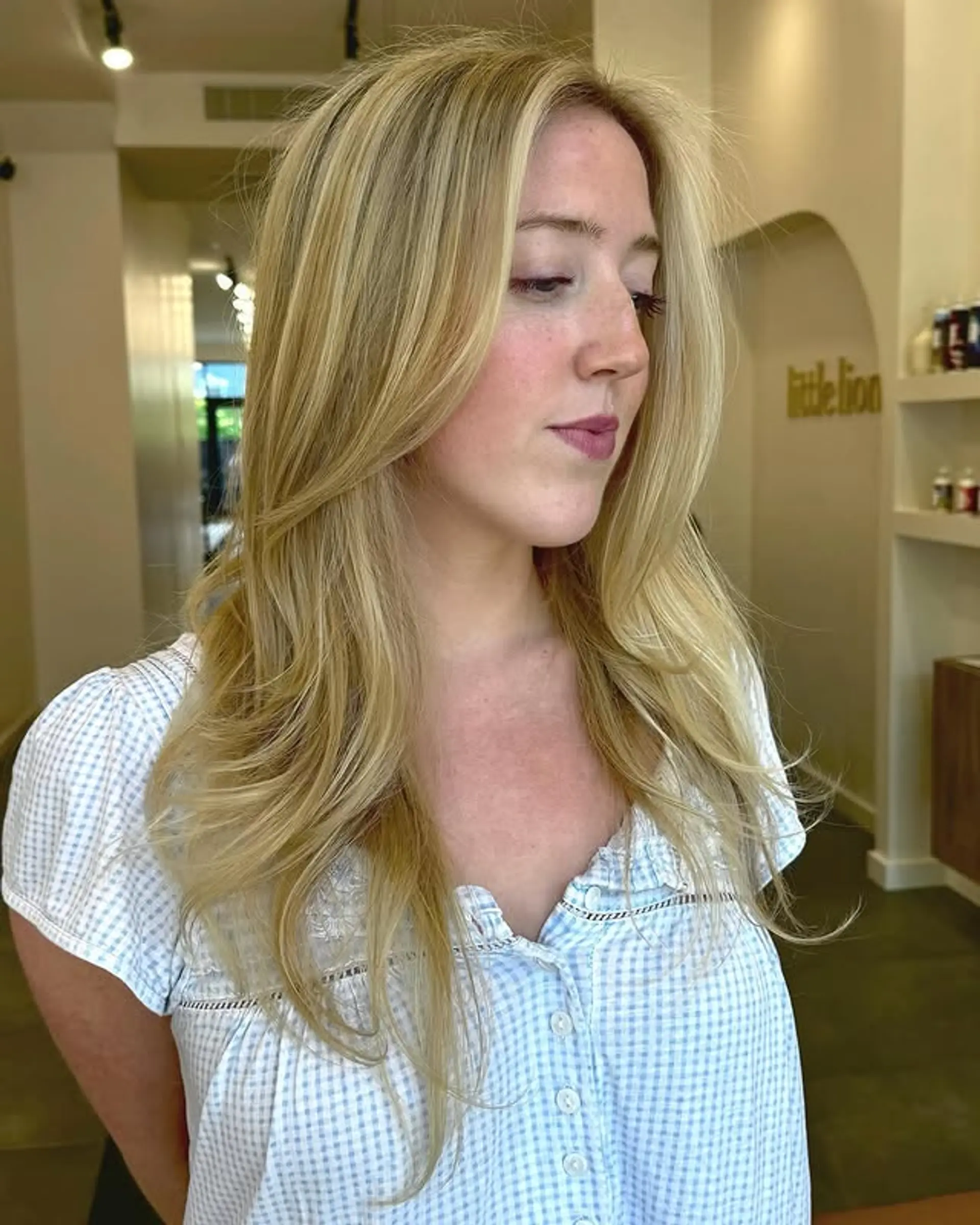 Long layered haircut with face-framing layers and subtle waves for a soft, feminine look. 1