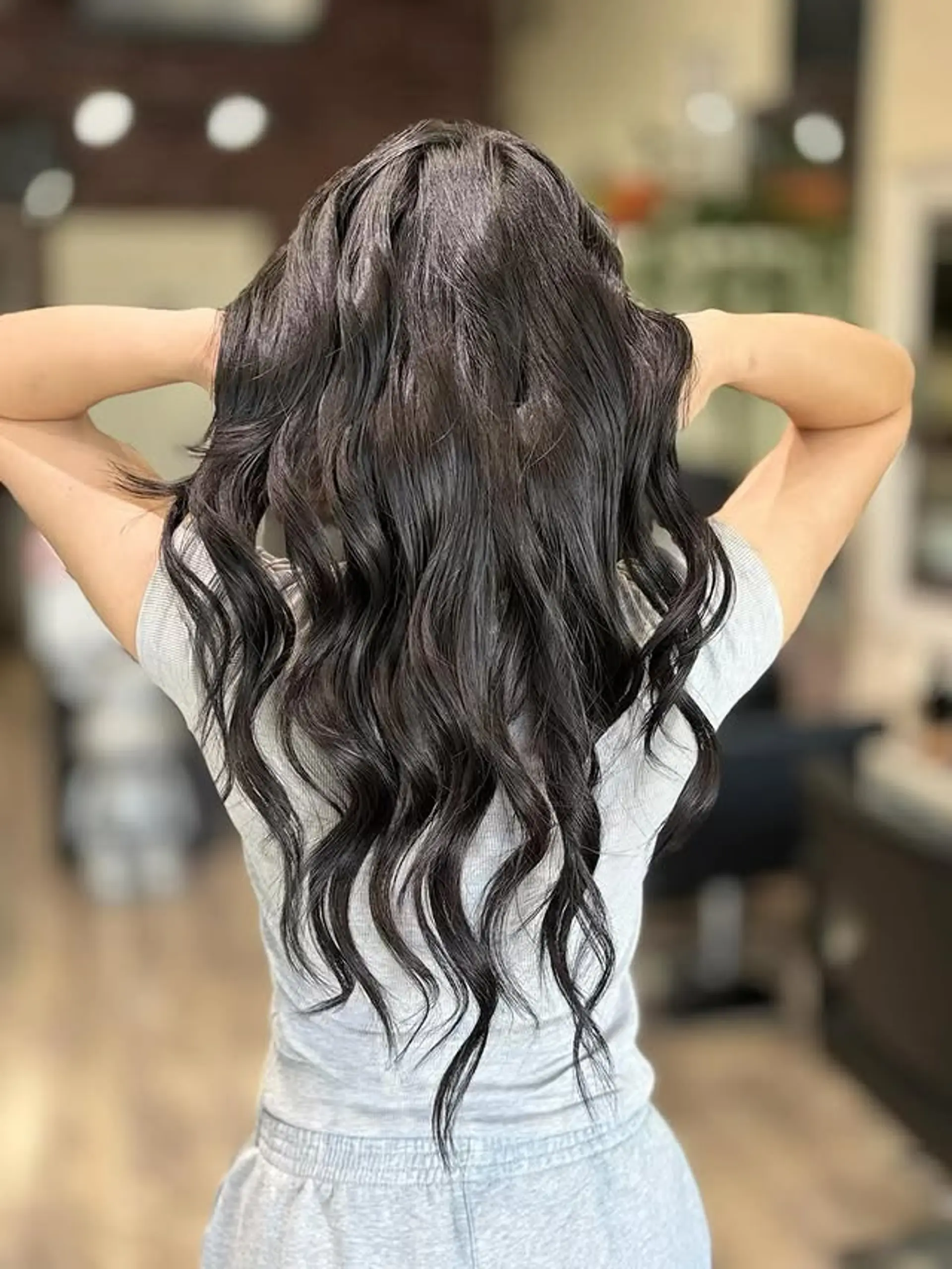 This style features long, luscious hair styled in soft, voluminous waves that fall to mid-back length. The waves are well-defined and appear to be achieved with a digital perm, providing a graceful and elegant flow with a touch of modern charm. 1