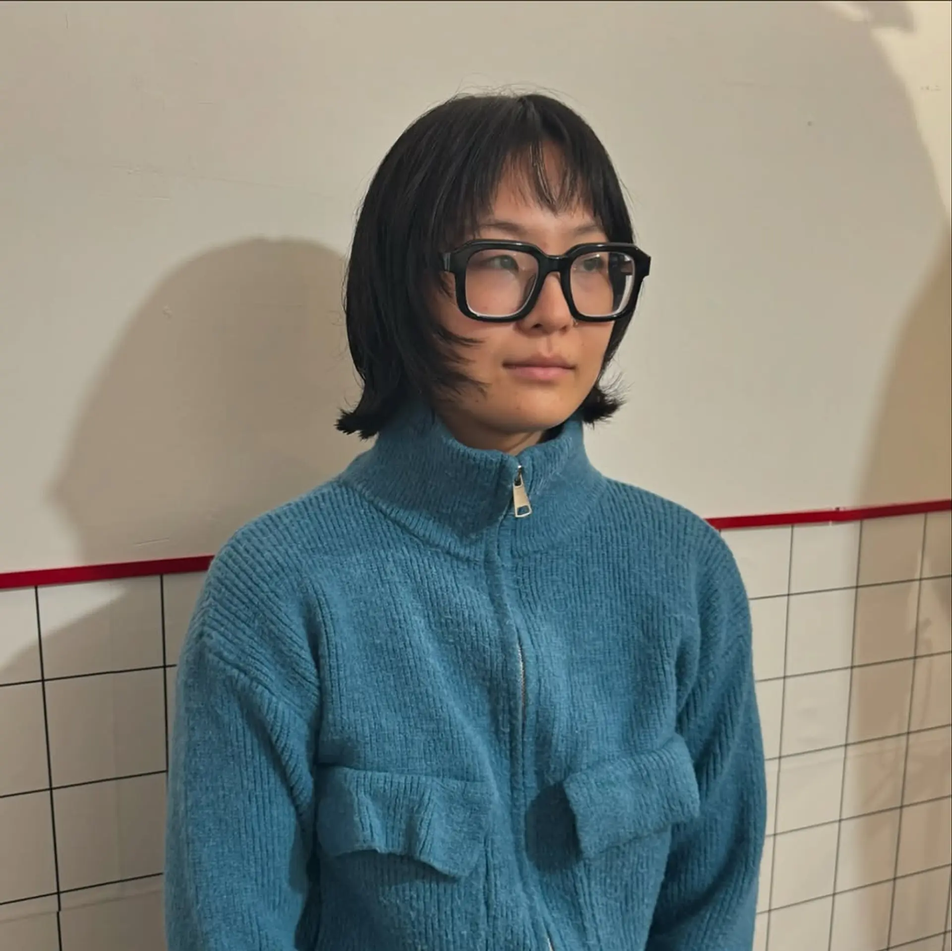A modern take on the Hime cut, featuring short, wispy bangs blended into face-framing chin-length layers, providing a structured yet textured bob aesthetic. 1