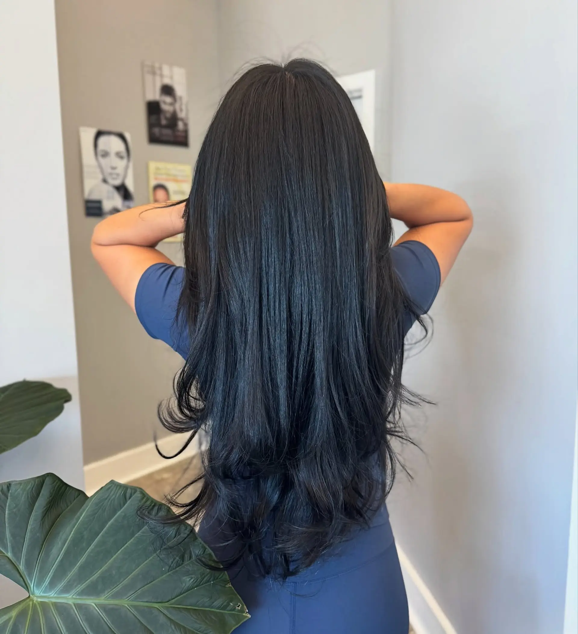 A long hairstyle with layers cut in a V-shape at the back, featuring face-framing layers for added dimension. 1