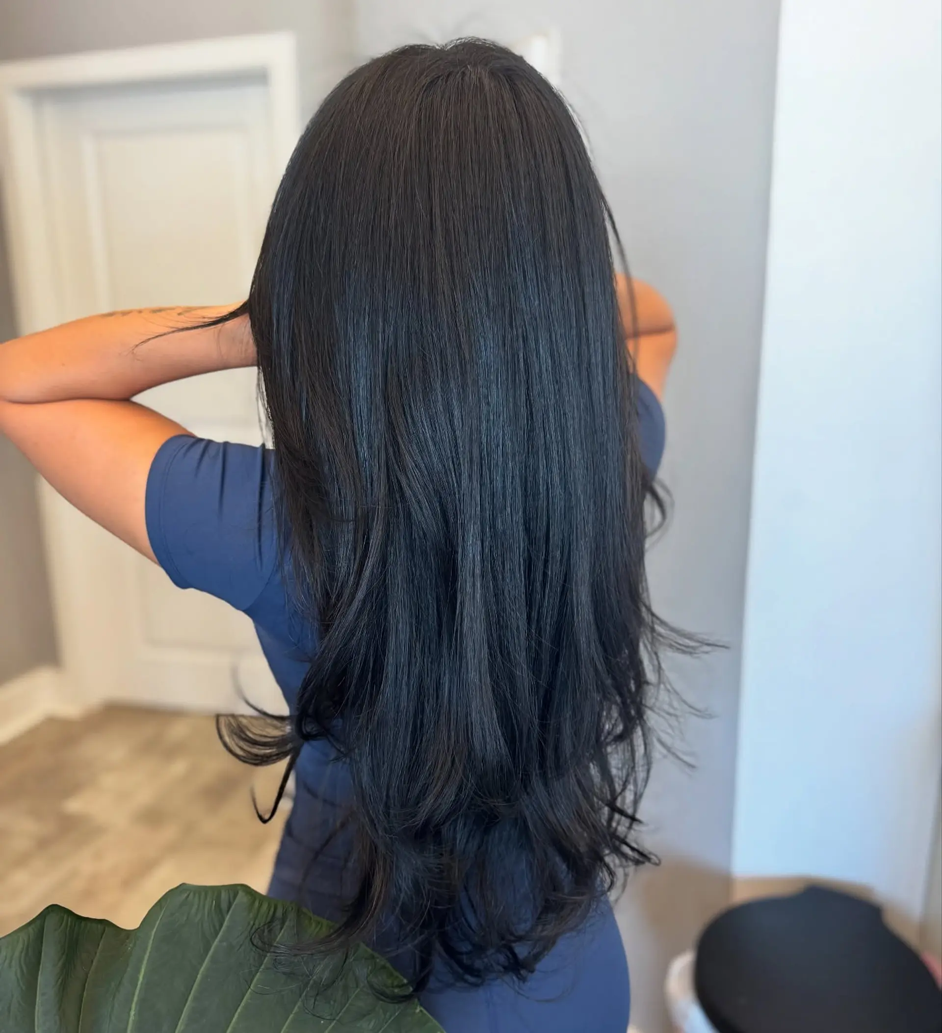 A long hairstyle with layers cut in a V-shape at the back, featuring face-framing layers for added dimension. 2