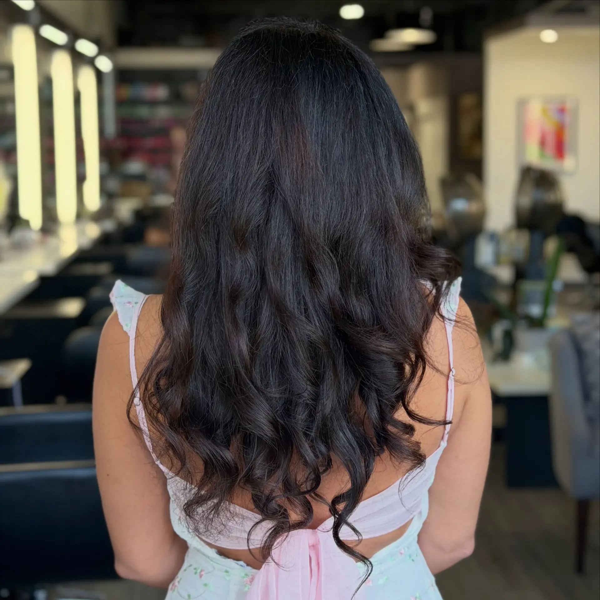 Long brunette hair styled in glossy, soft waves with textured ends. 1